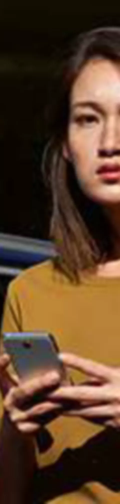 BMW ConnectedDrive overview woman with smartphone in front of BMW