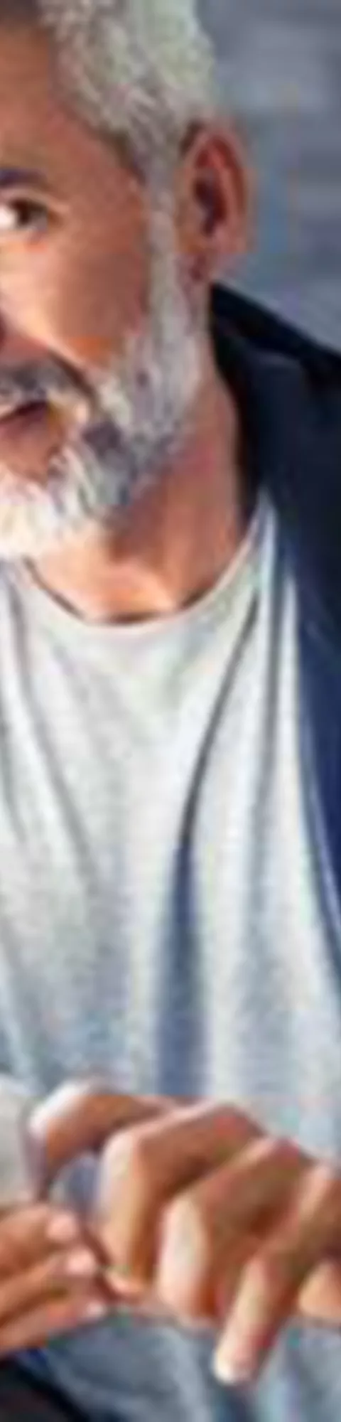 BMW ConnectedDrive Store Man with smartphone sitting on sofa