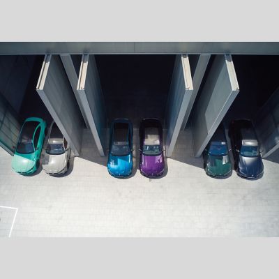 Several BMW vehicles sporting different paintwork in a car park