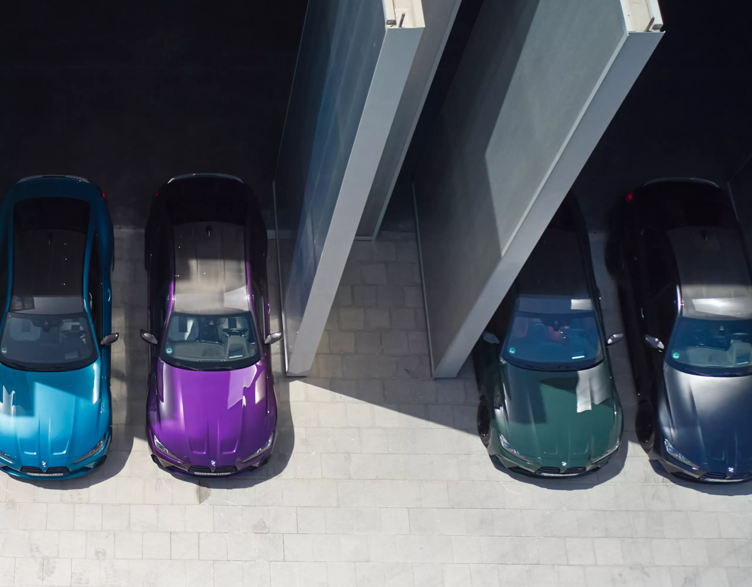 Four BMW vehicles with different BMW Individual paint finishes from an aerial perspective