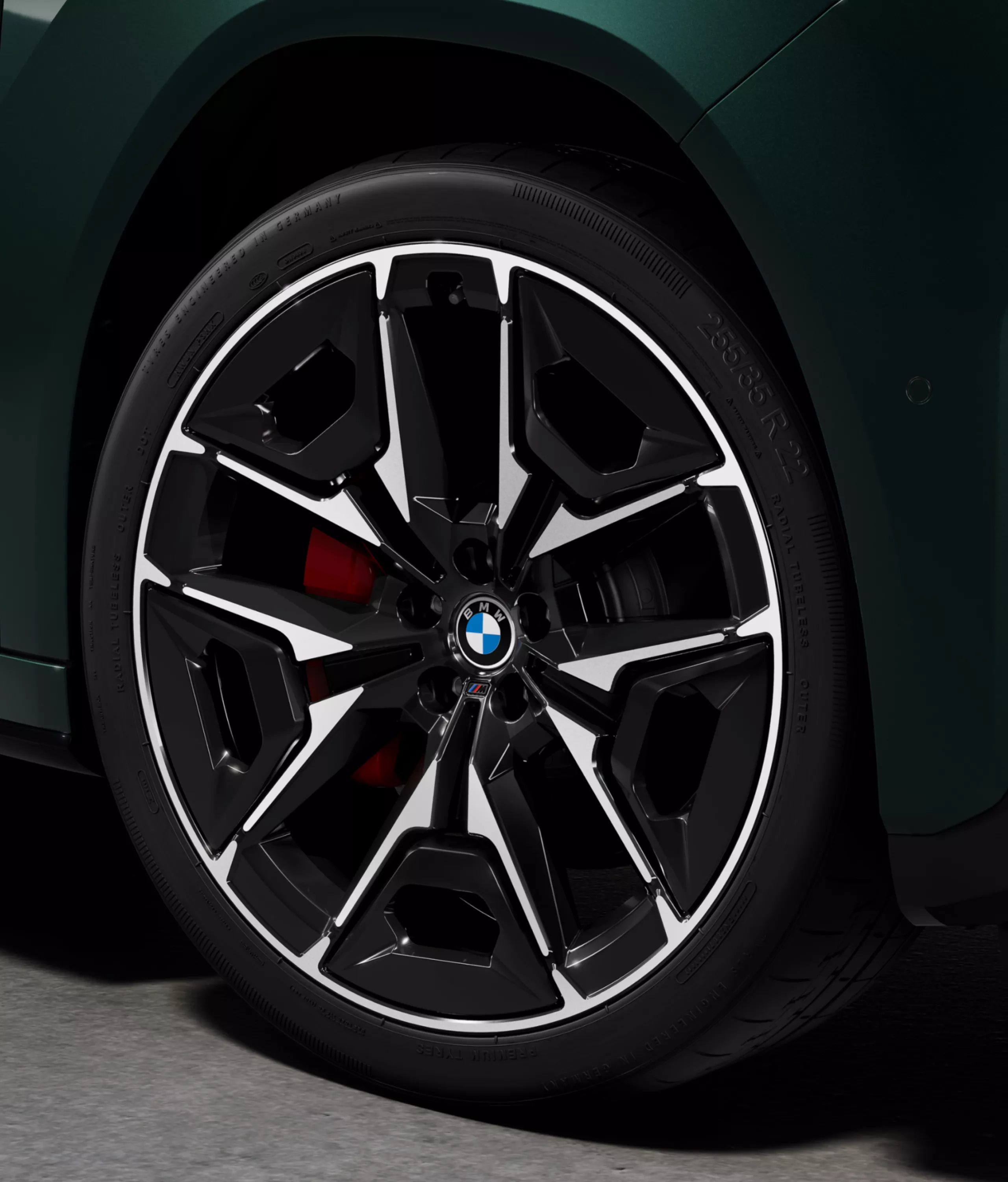 Close-up of a BMW light alloy wheel with visible red M Sport brake caliper on the BMW iX3 M60 xDrive