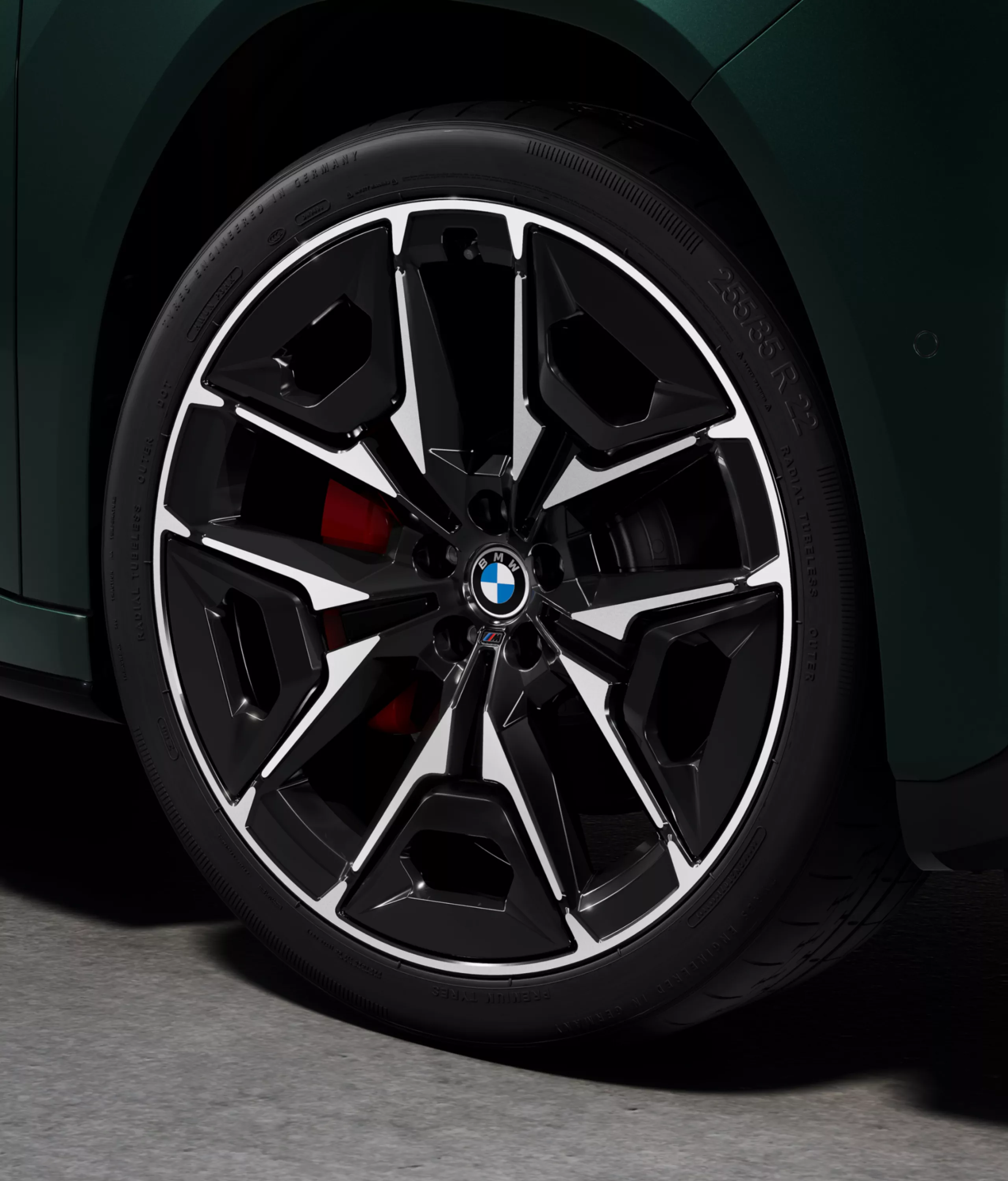 Close-up of a BMW light alloy wheel with visible red M Sport brake calliper on the BMW iX3 M60 xDrive