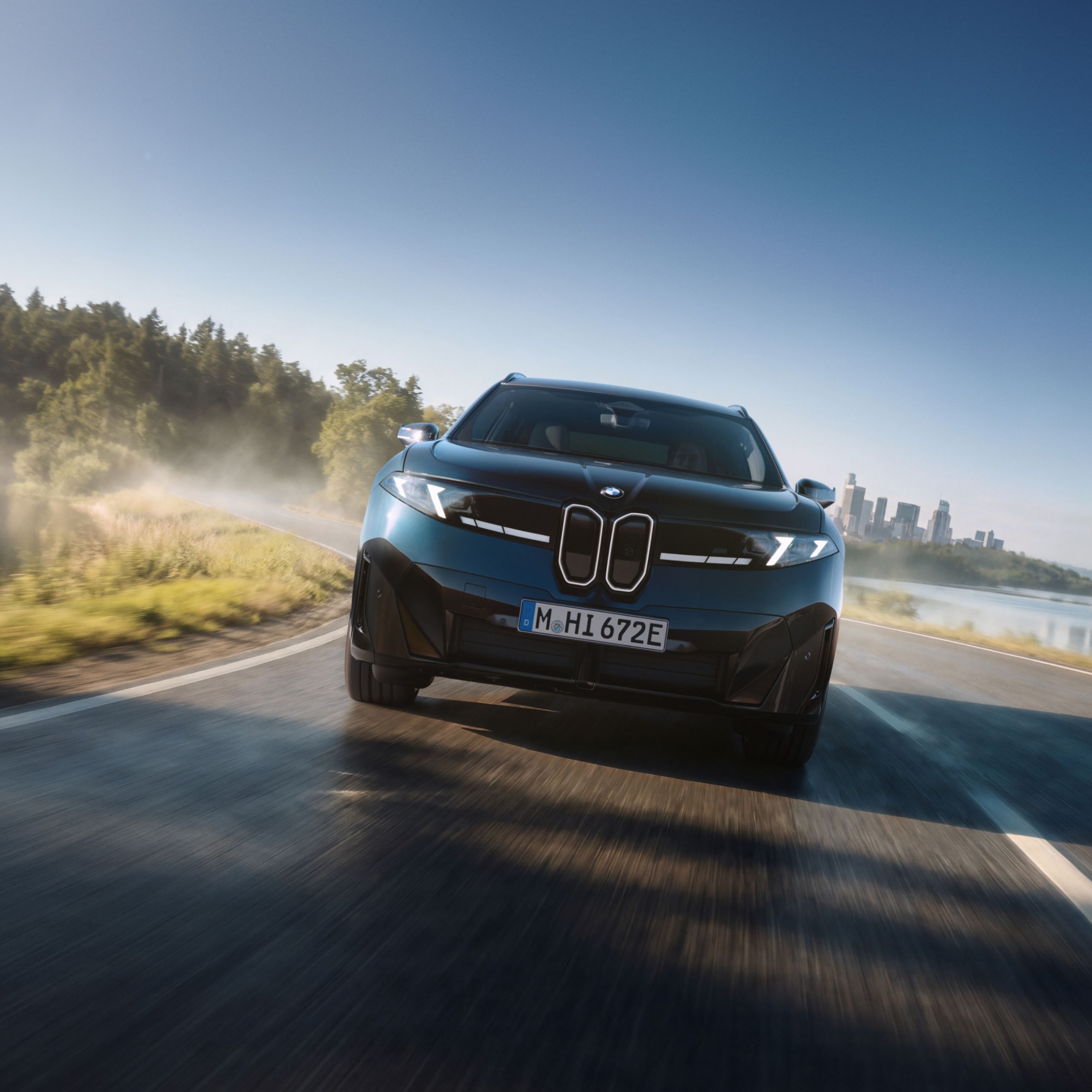The BMW iX3 M60 xDrive driving on a highway