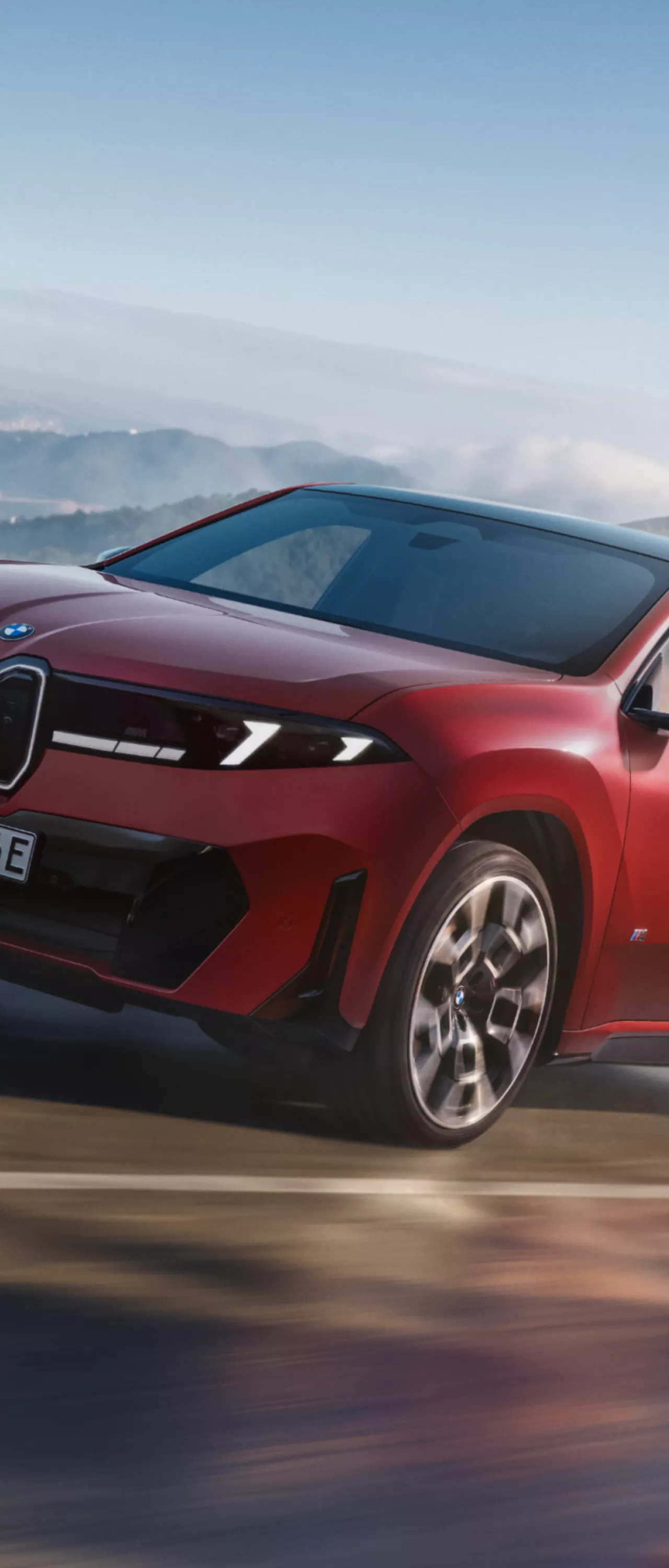 La BMW iX4 M60 xDrive dans un virage, illustrant le fonctionnement de la suspension adaptative M ADAPTIVE