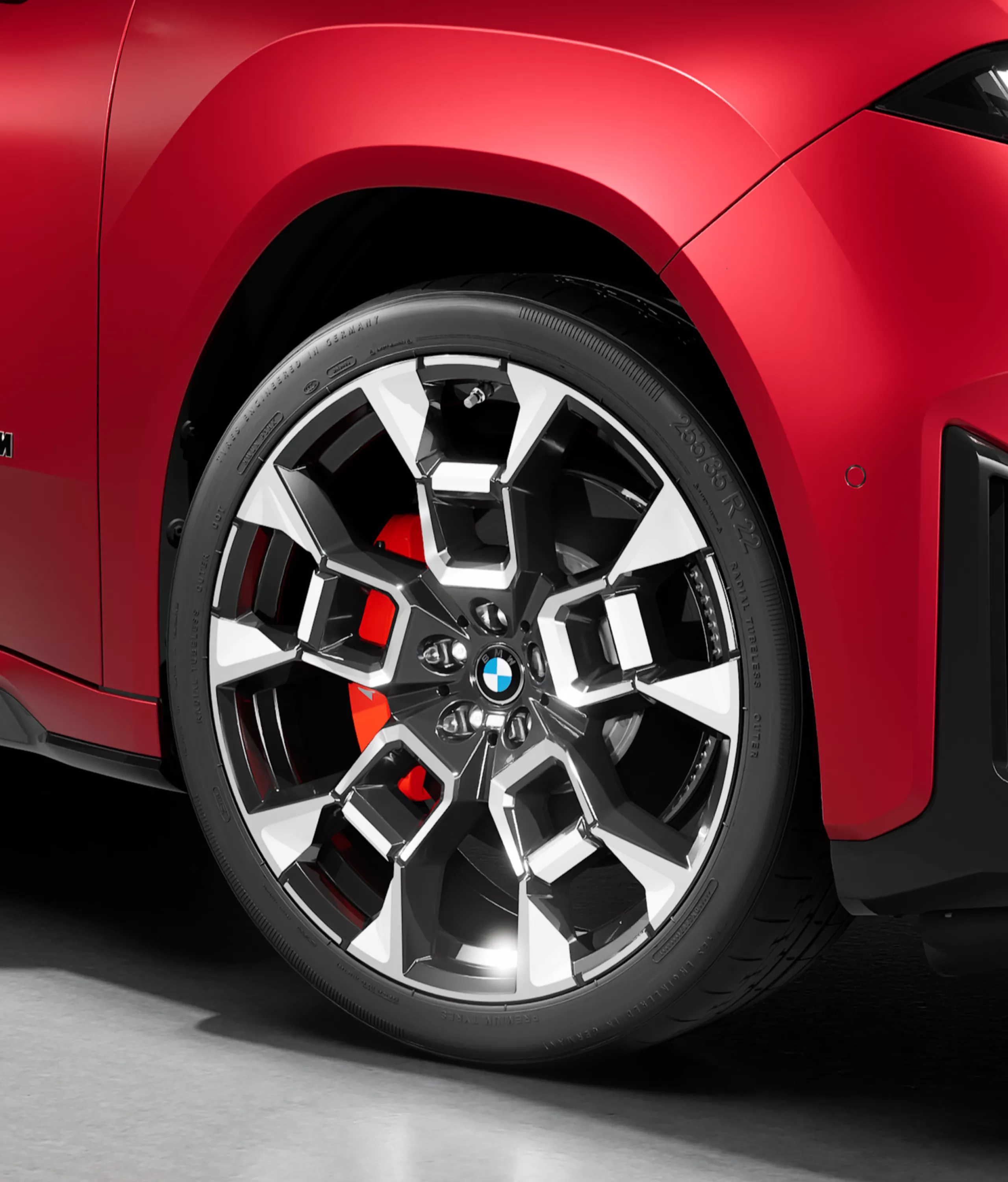 Close-up of a BMW alloy wheel with visible red M Sport brake calliper on the BMW iX4 M60 xDrive