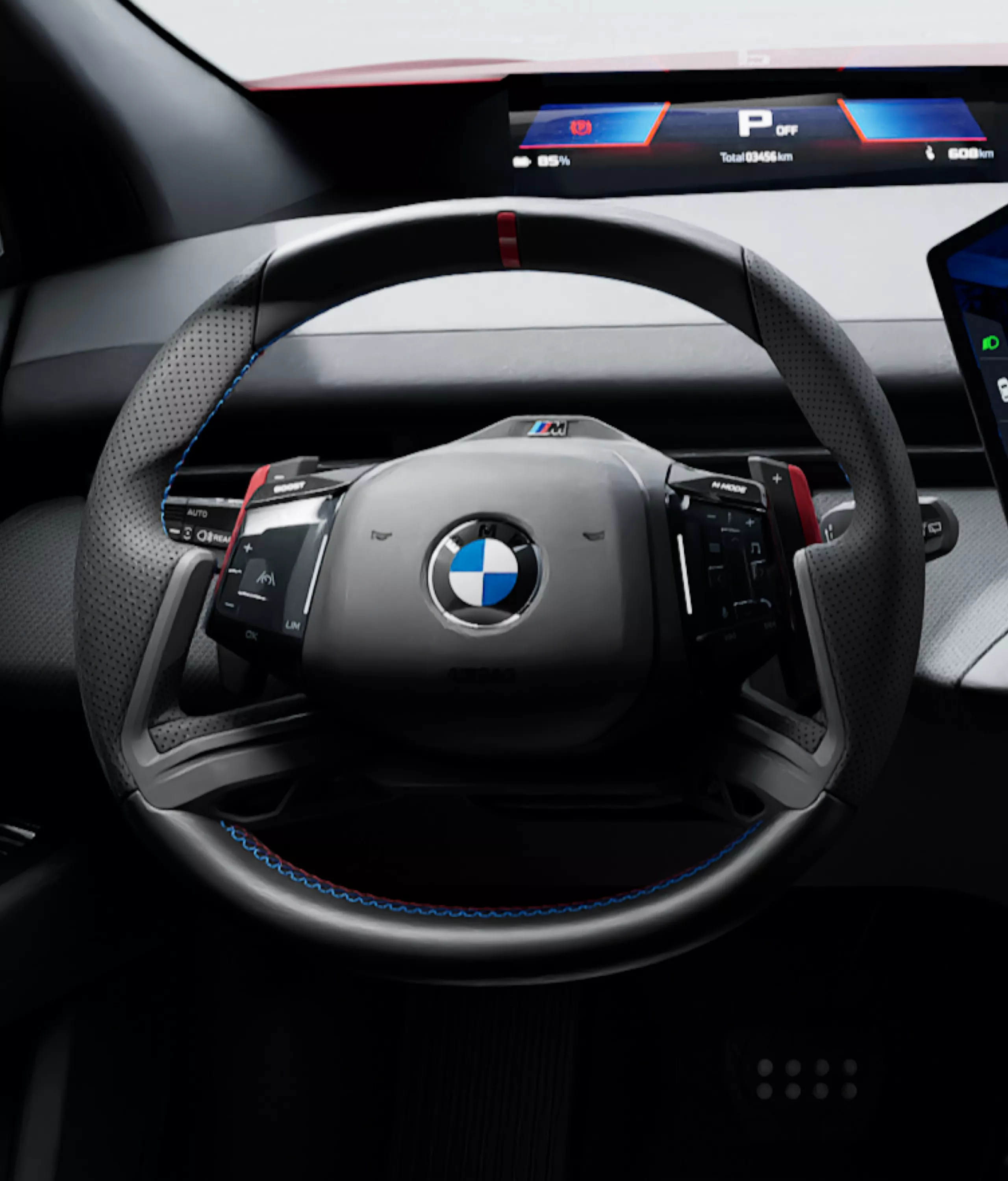 BMW M Sport Steering Wheel with red shift paddles in the BMW iX4 M60 xDrive cockpit