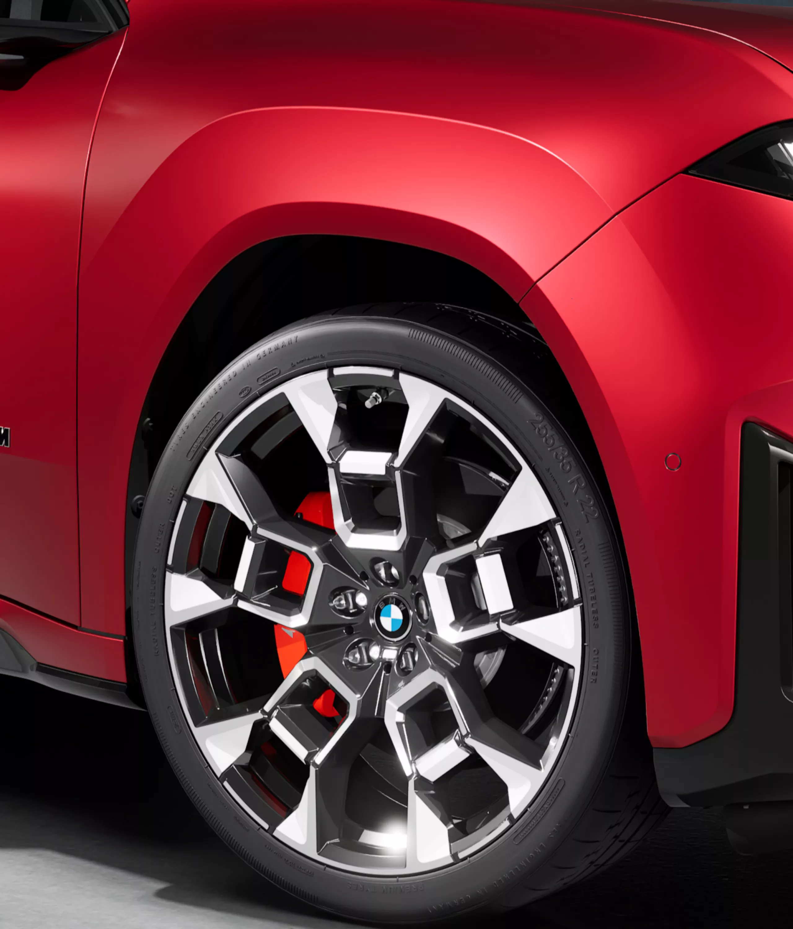 Close-up of a BMW alloy wheel with visible red M Sport brake calliper on the BMW iX4 M60 xDrive