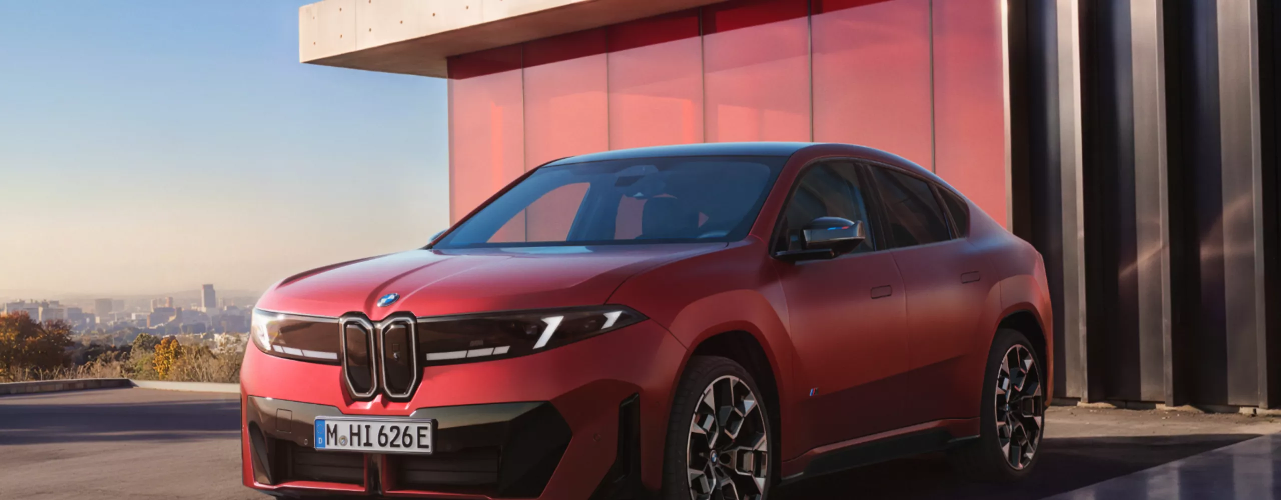 Teaser of the BMW iX4 M60 xDrive with distinctive yellow lighting elements as a preview of the next Model Hub