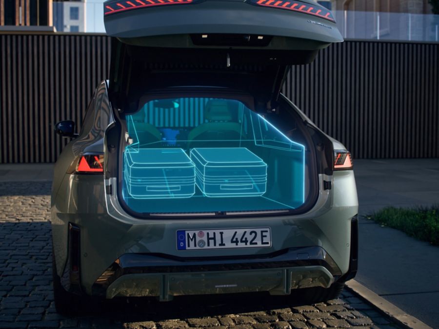 BMW iX4 with the tailgate open, showing the cargo area
