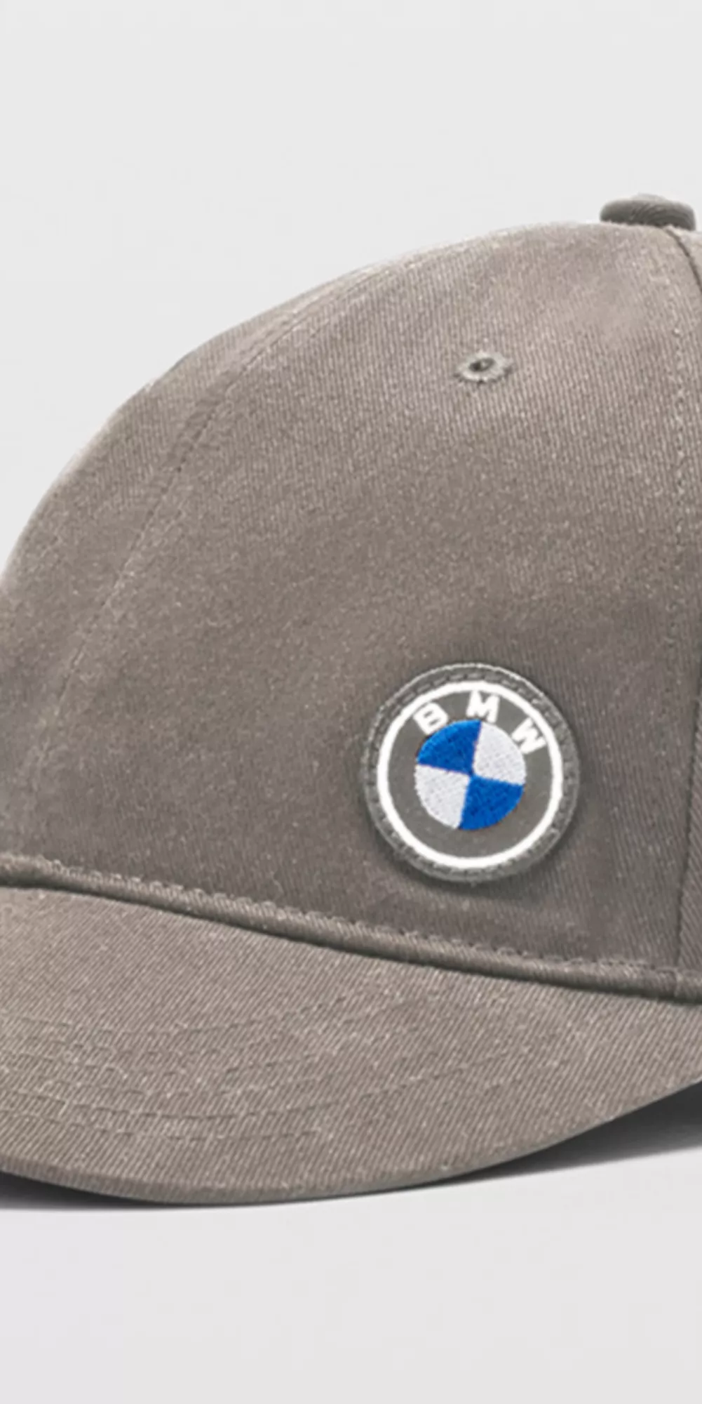 BMW Lifestyle turquoise BMW M shirt with white BMW M Logo, turquoise BMW M baseball cap and turquoise BMW M bath towel worn by a young man