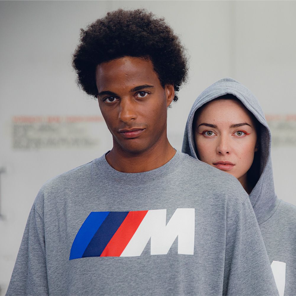 BMW Lifestyle BMW M Motorsport Collection featuring a hoodie, shorts, and t-shirt, worn by two young persons