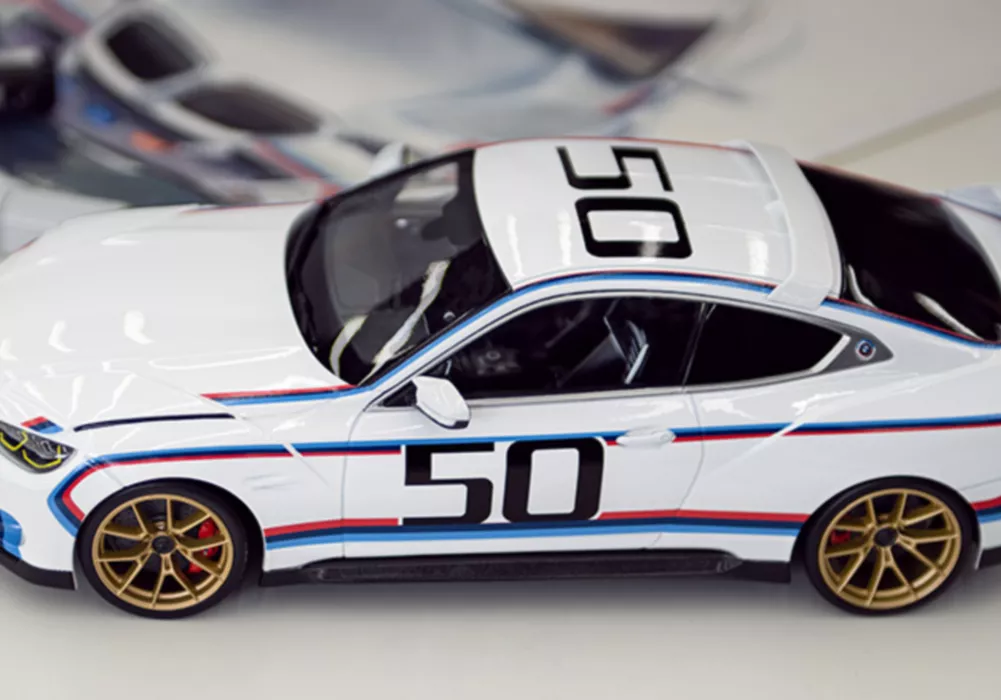 BMW Lifestyle BMW Miniatures featuring a BMW M3 E30, BMW M1, and BMW 3 Series E30 in a miniature setting 