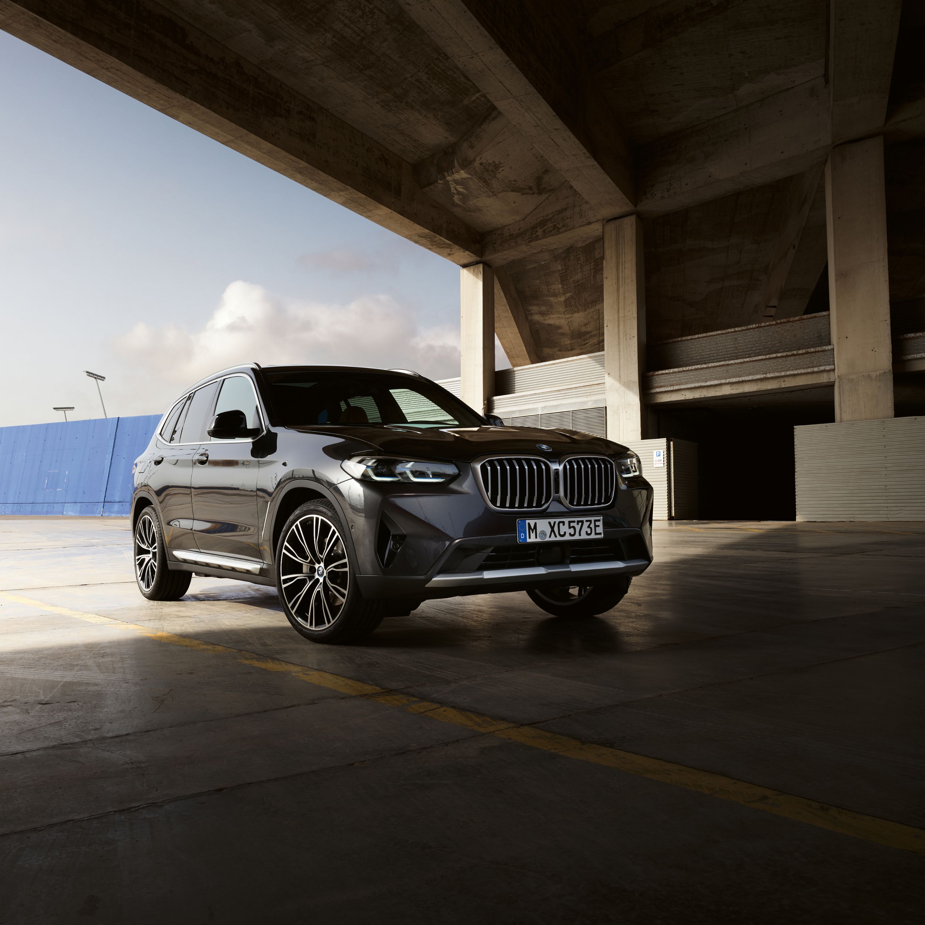BMW X3 G01 SUV parked beneath a underpass of an industrial complex