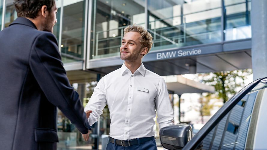BMW Service BMW employee shakes customers hand