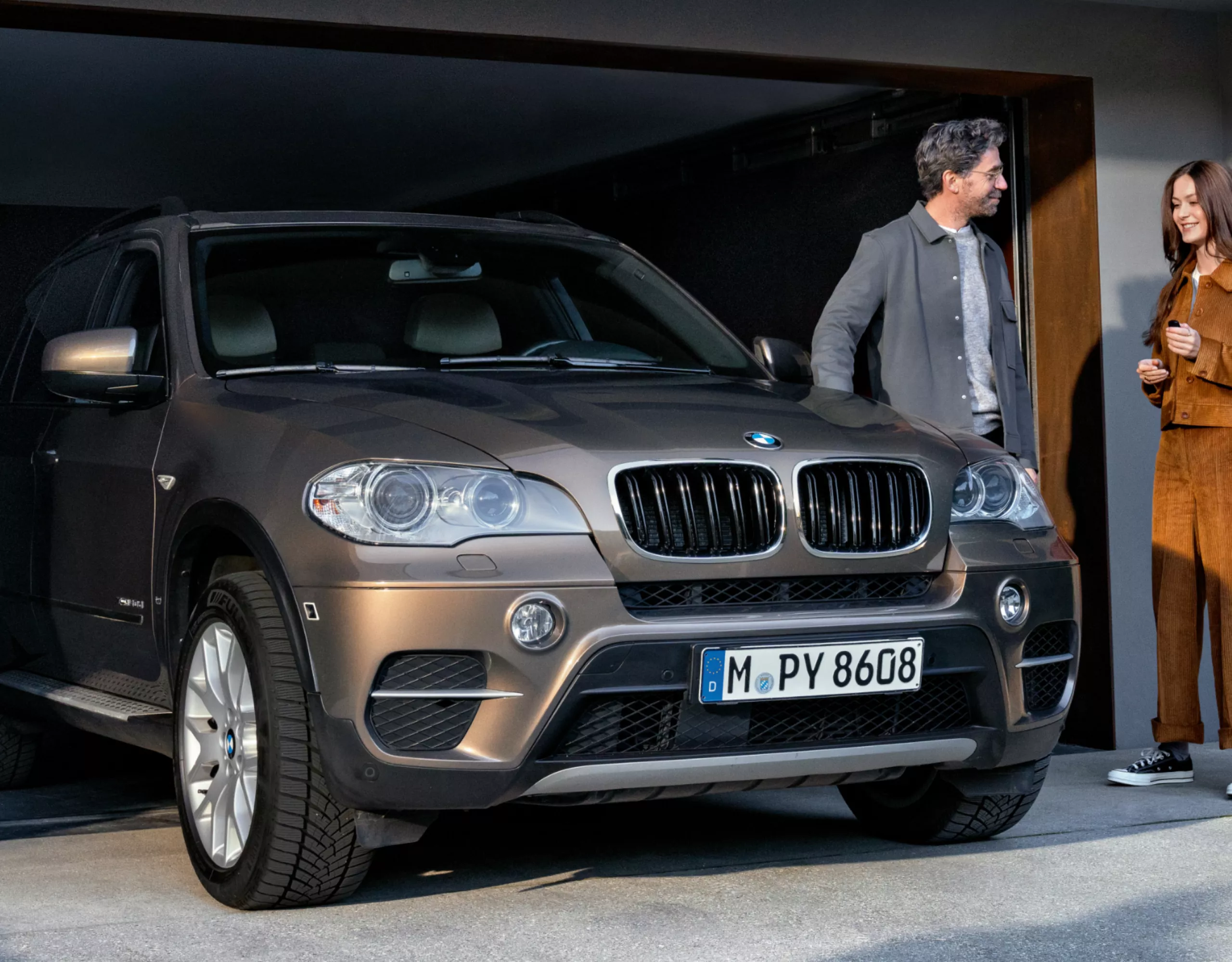 BMW Value Service BMW steht vor Garage mit Models