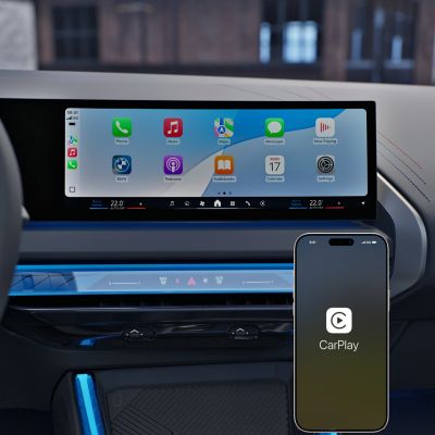 Smartphone apps are visible on the central display