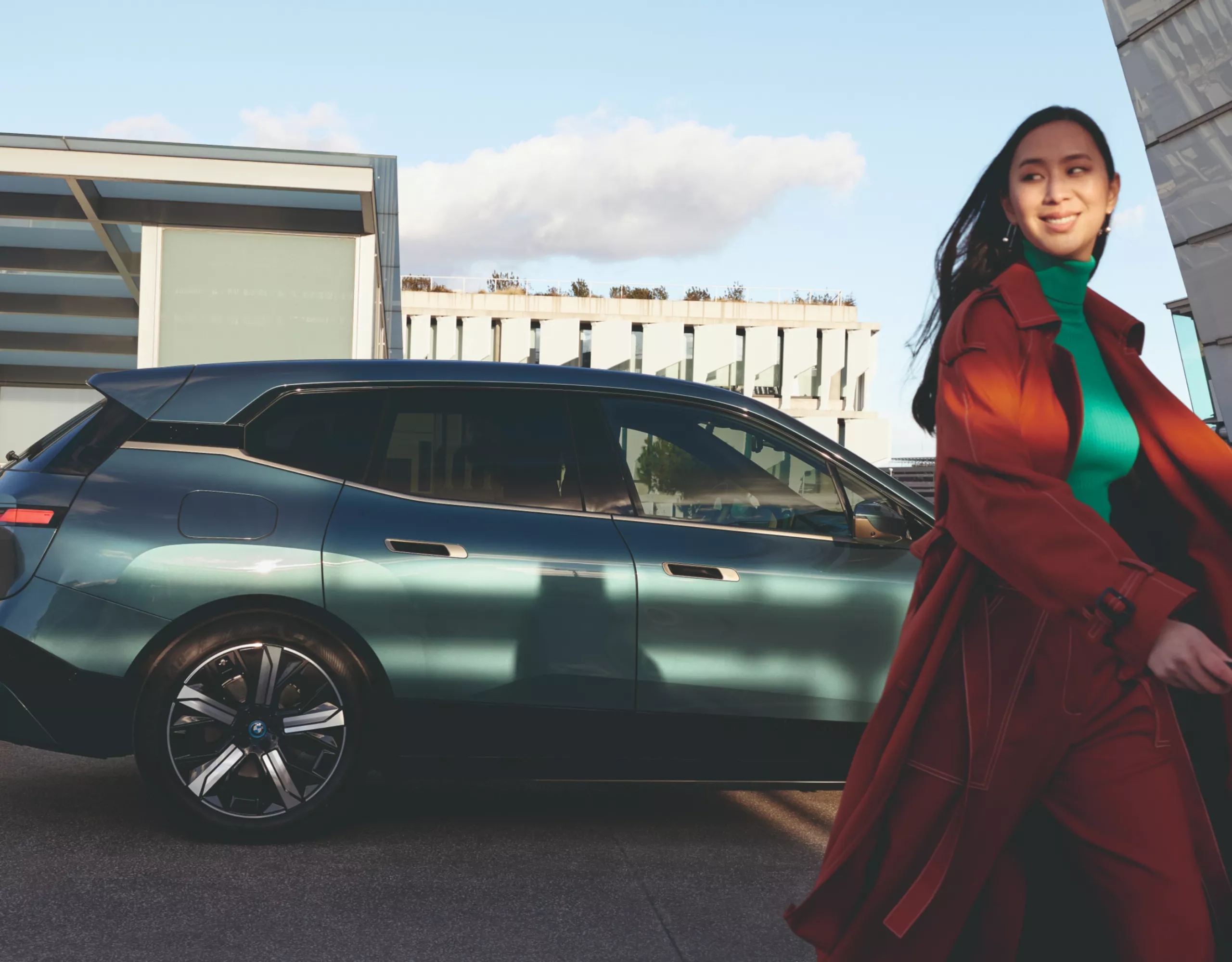 Person walking away from a parked BMW