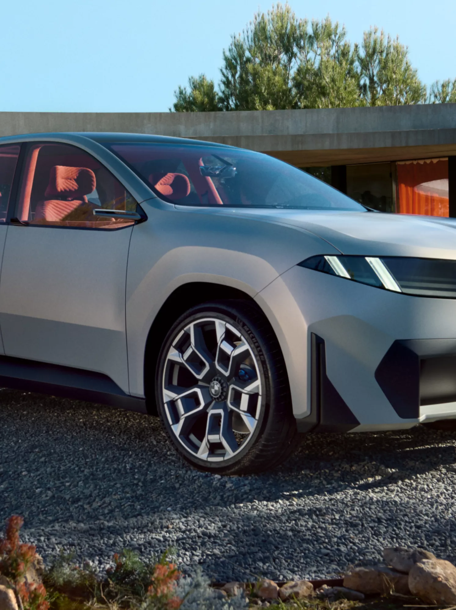 A fully electric BMW is parked in a driveway
