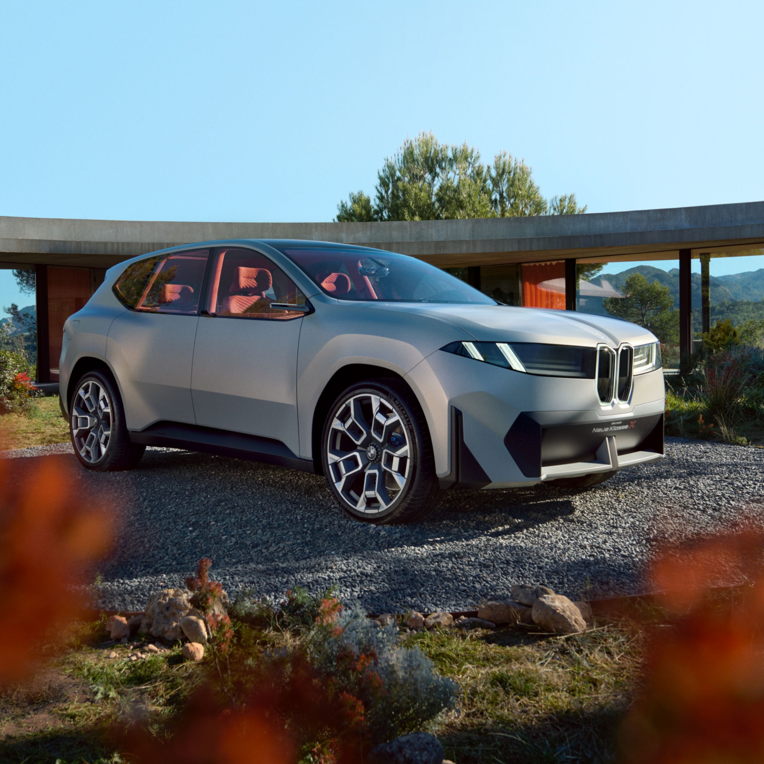 A fully electric BMW is parked in a driveway