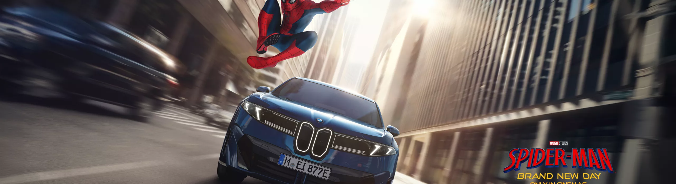 Spider-Man in a heroic pose next to the BMW iX3.