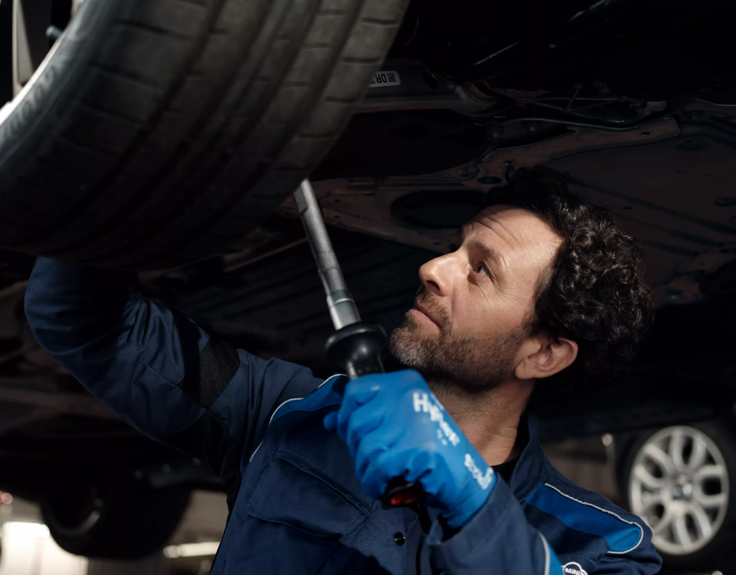 A workshop technician repairs a tyre