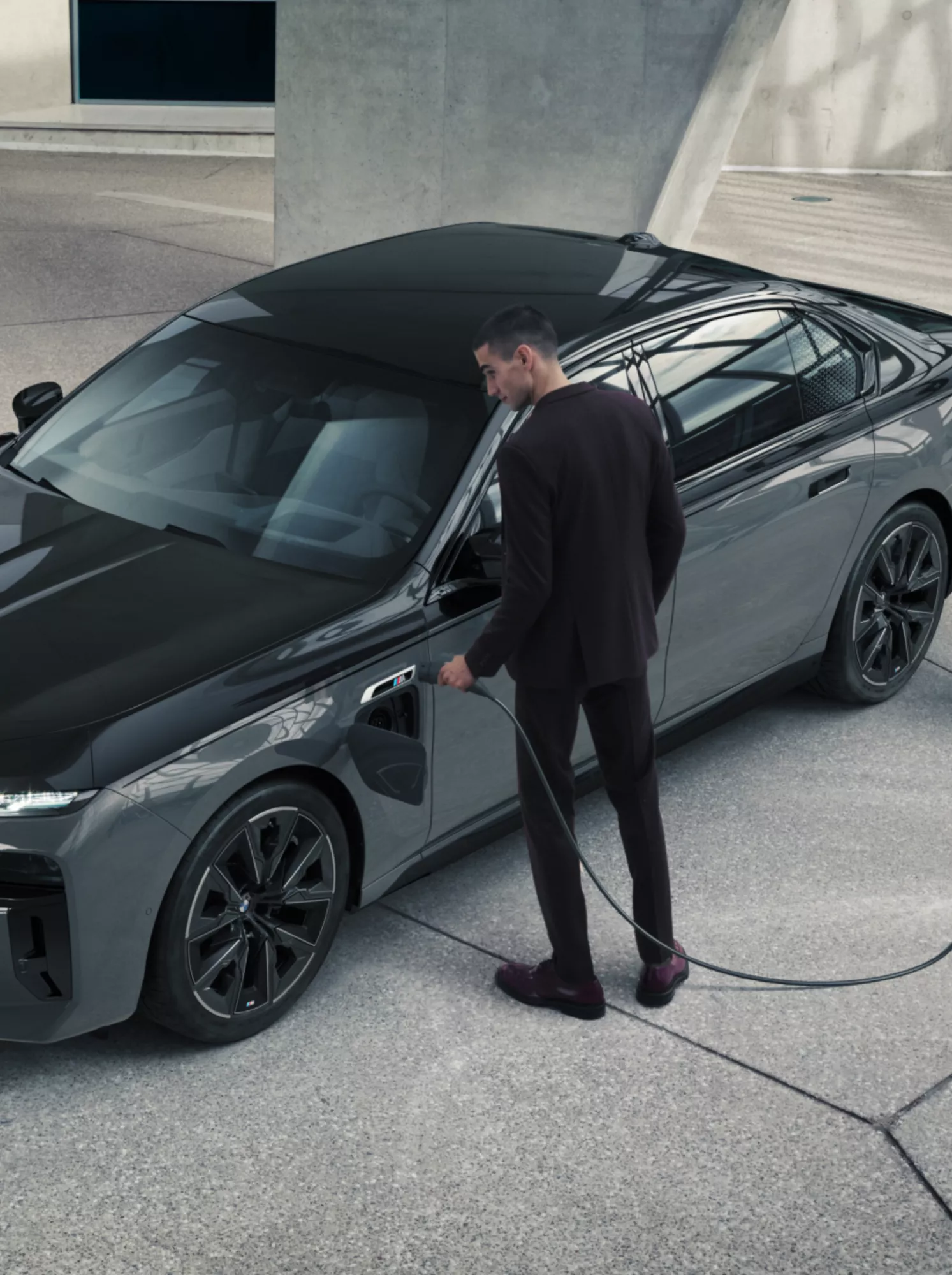 BMW 7 series plug-in hybrid vehicle connected to a charging station