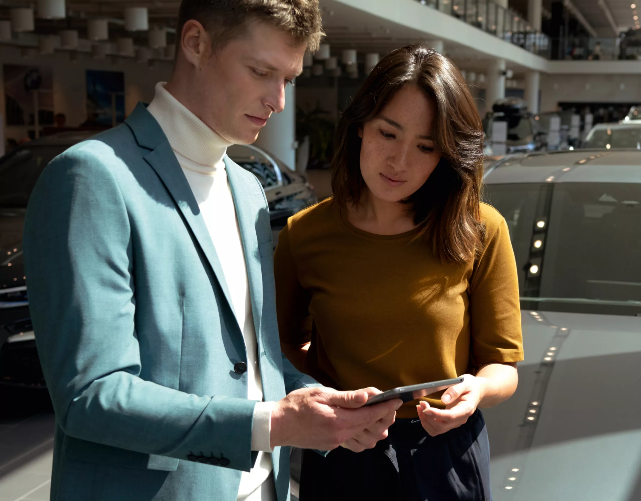A man and a woman are looking at a tablet together