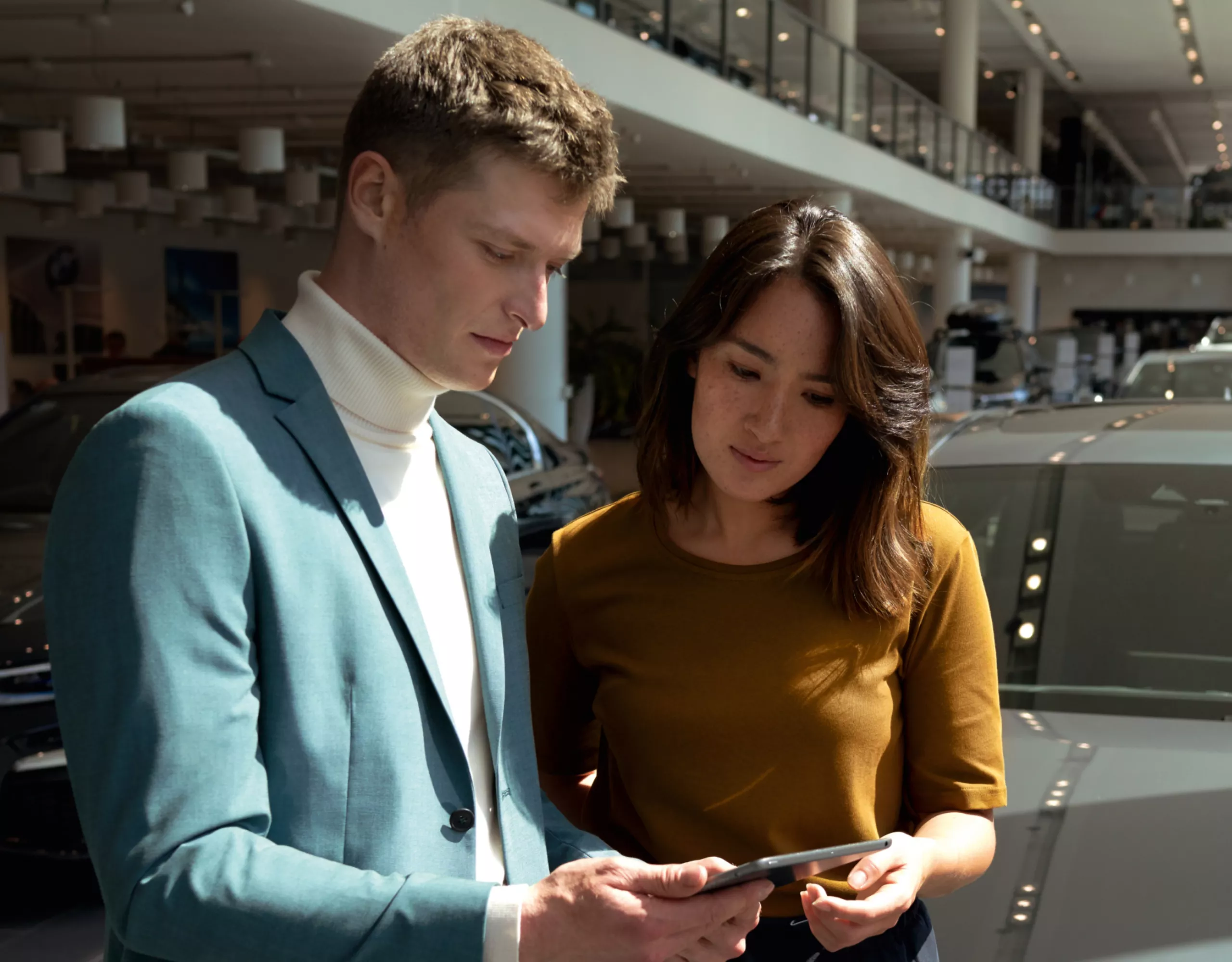 A man and a woman are looking at a tablet together