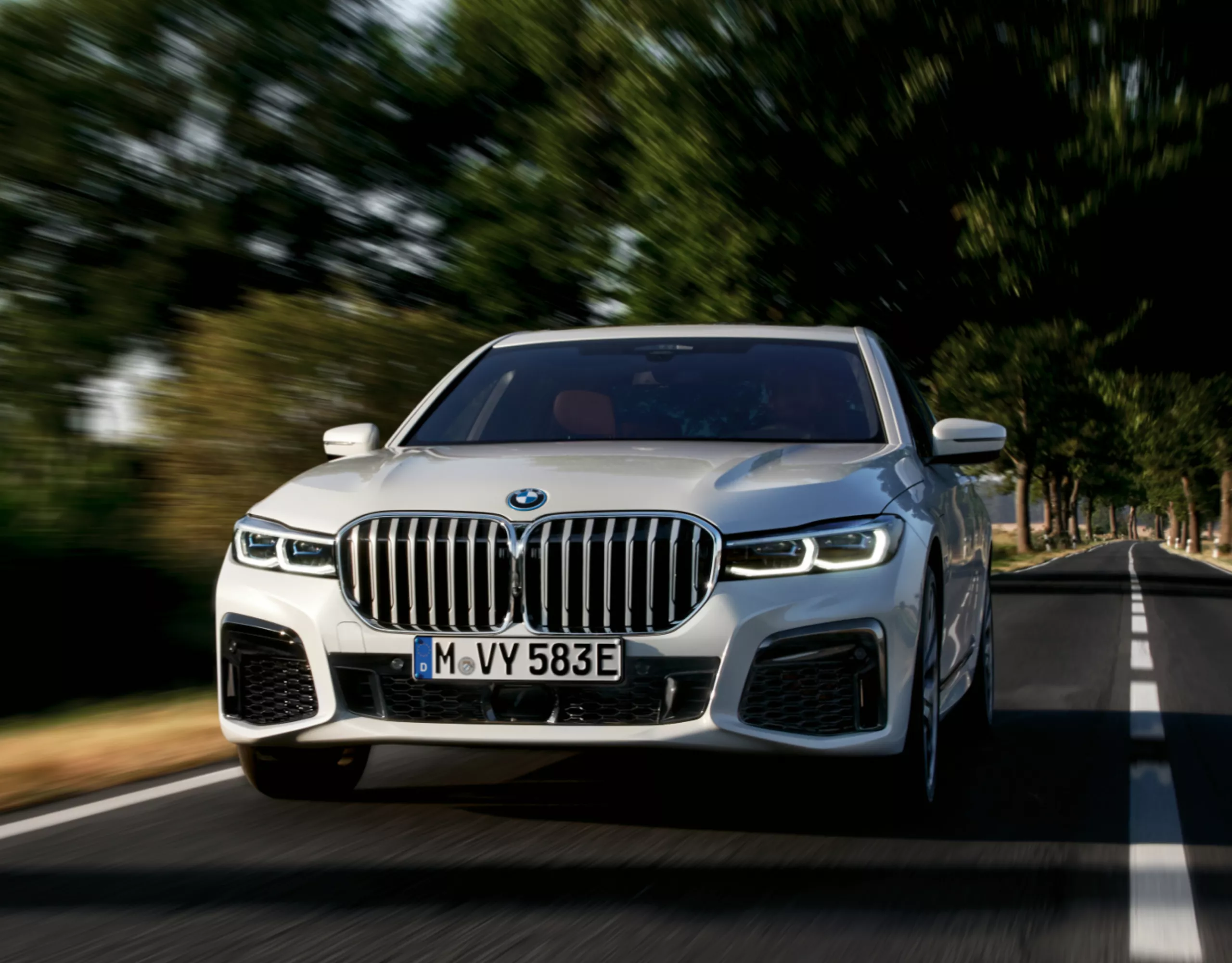 A BMW plug-in hybrid is driving on a city street