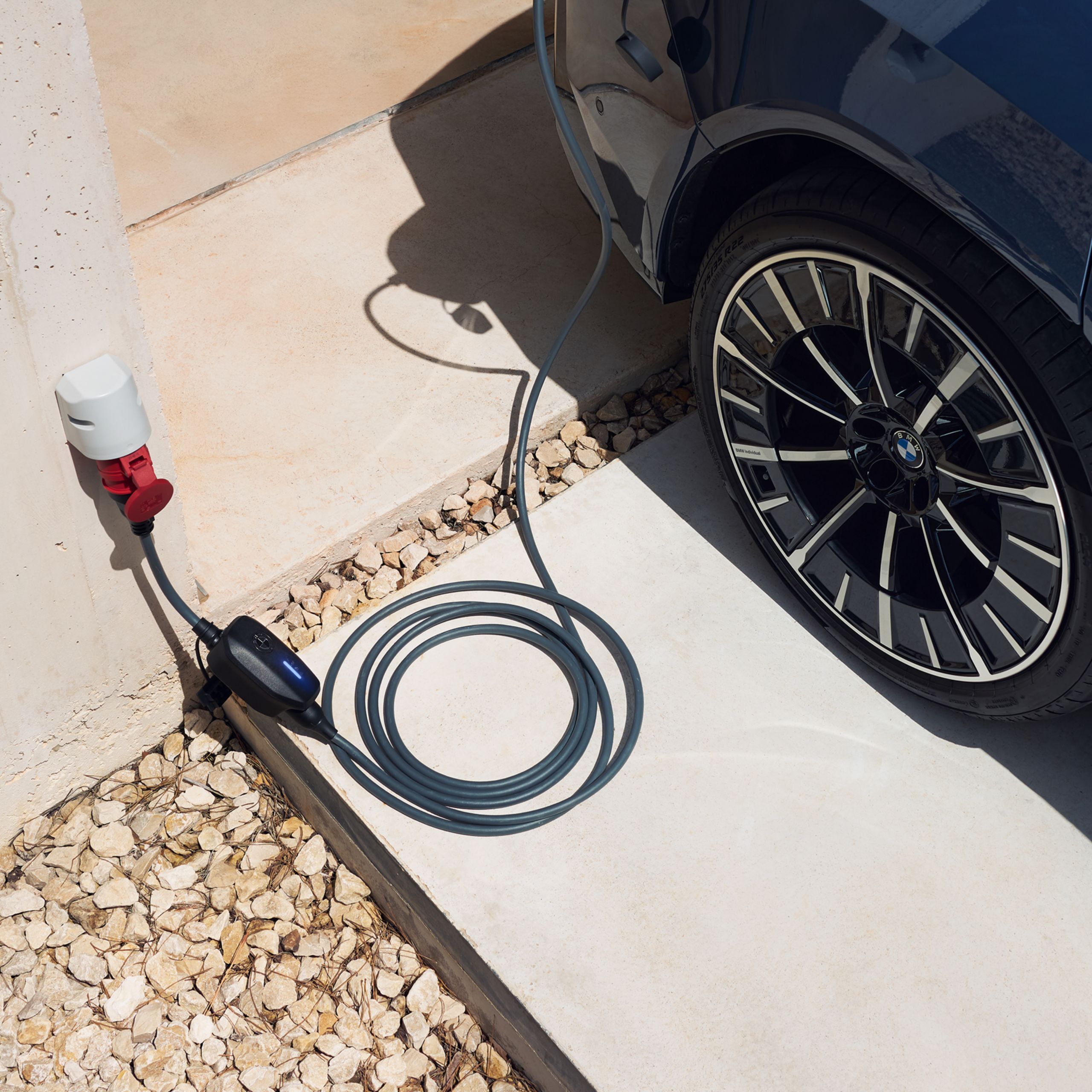 A multifunction charger is plugged into a socket mounted to a wall