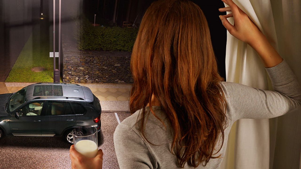 Woman looking out to BMW