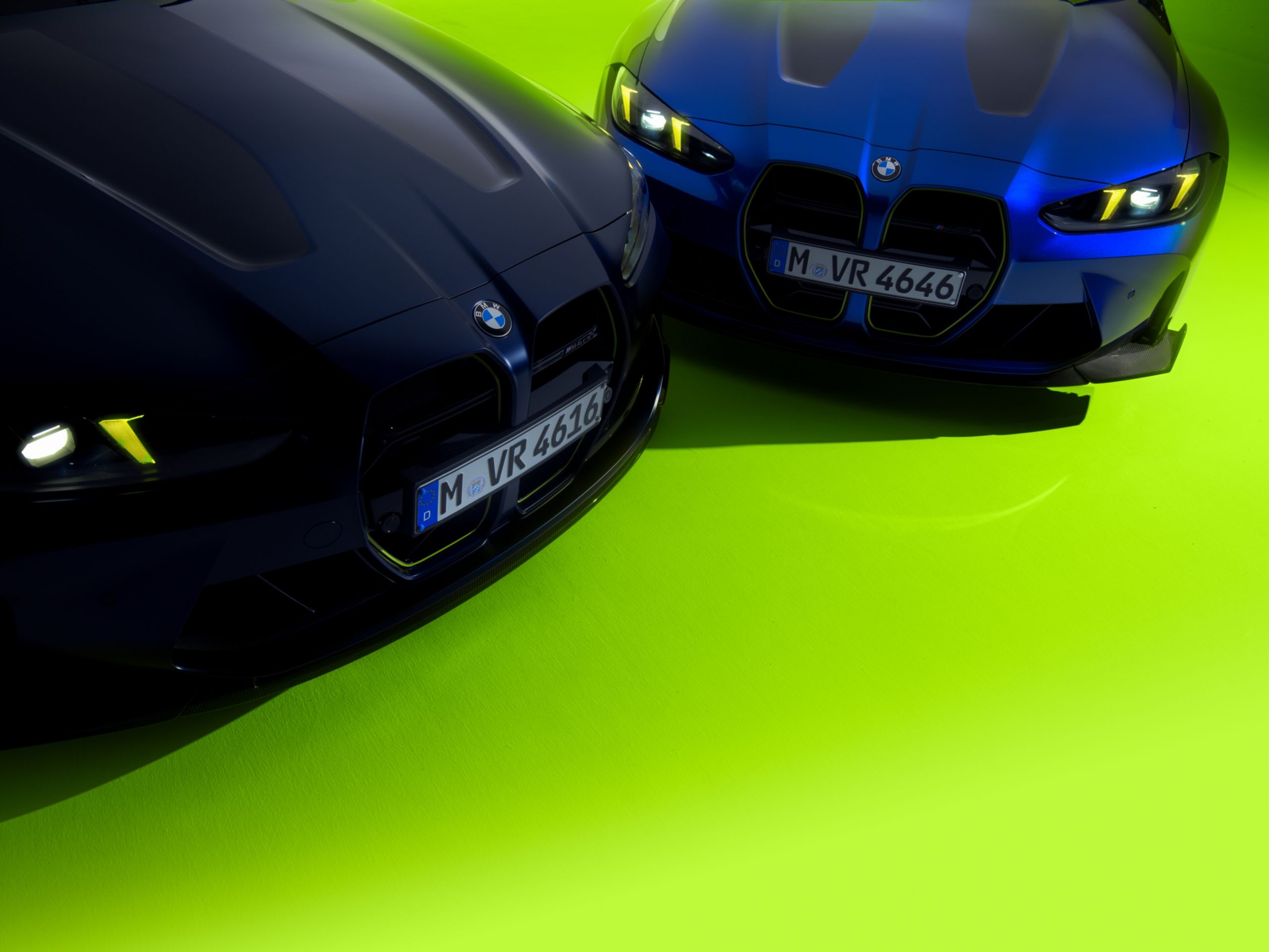 A high angle shot of the fronts of two M4 VR46 vehicles, one in Frozen Tanzanite Blue Metallic and the other in Marina Bay Blue Metallic