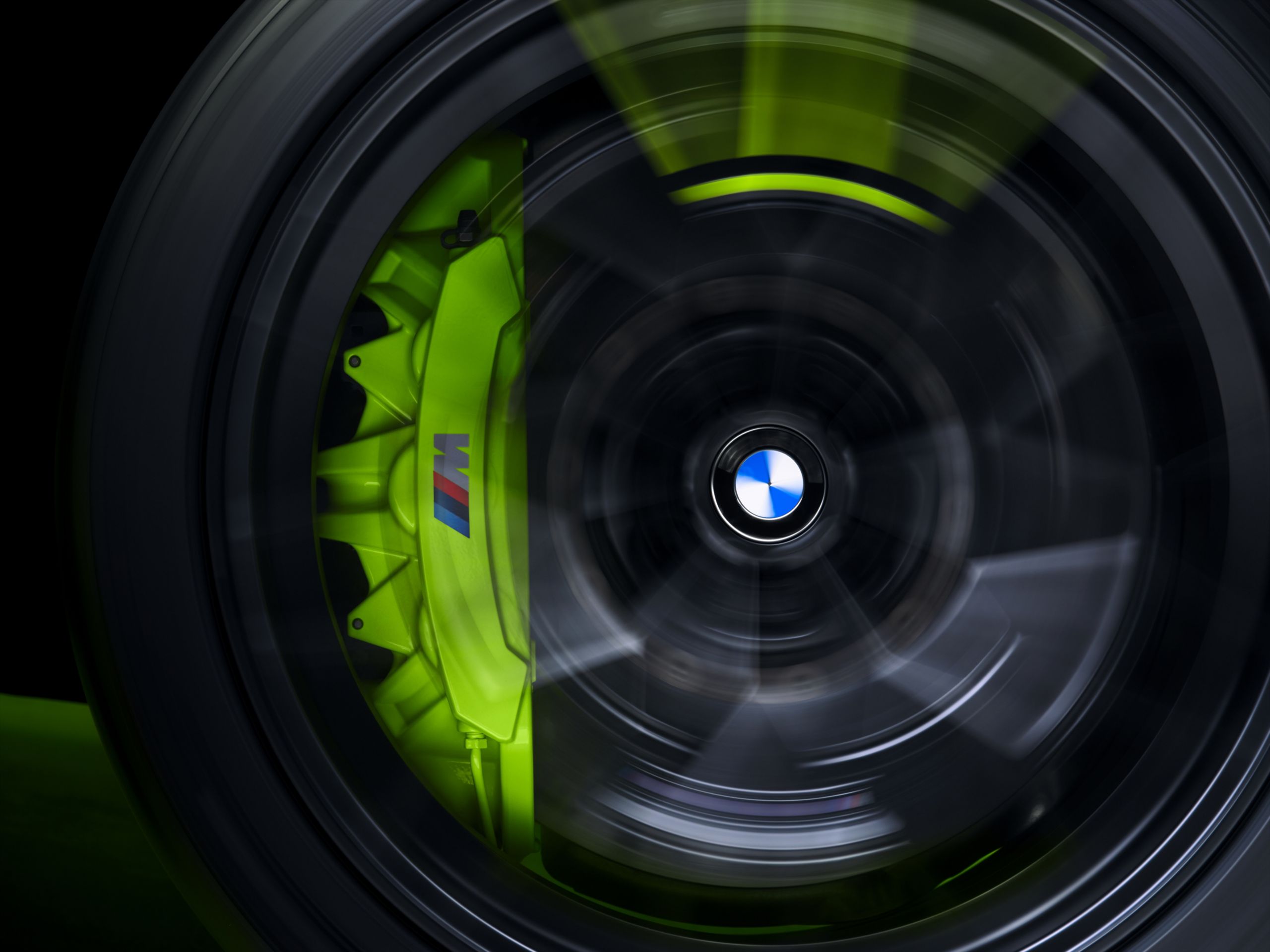 A close up of a wheel on the BMW M4 CS VR 46 in motion, revealing the brake calipers with yellow trim