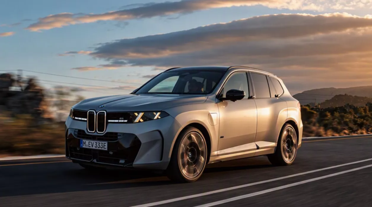 Front three-quarter view of the new 2027 BMW X5 (G65 generation) luxury SUV featuring Neue Klasse-inspired grille design against a mountain background.