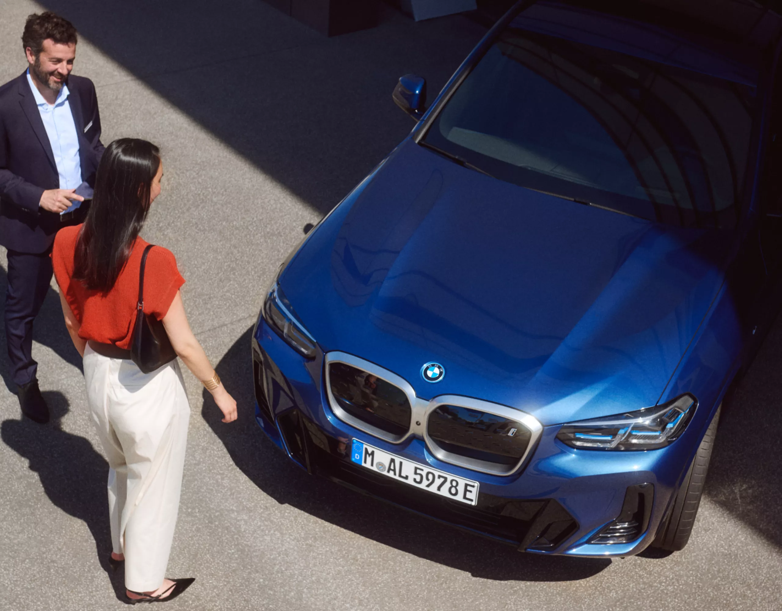 Ein Mann und eine Frau stehen vor einem BMW