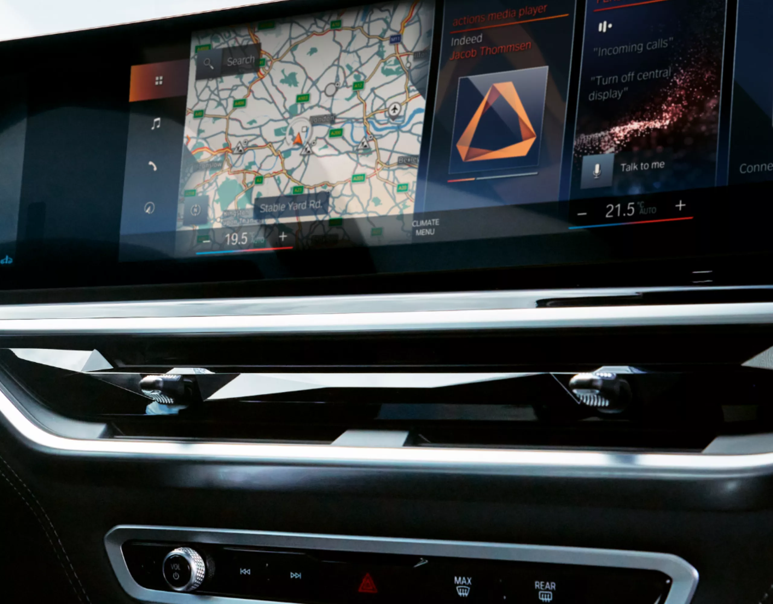 Curved display and ambient lighting in the BMW X6 with the map and media player active in the display