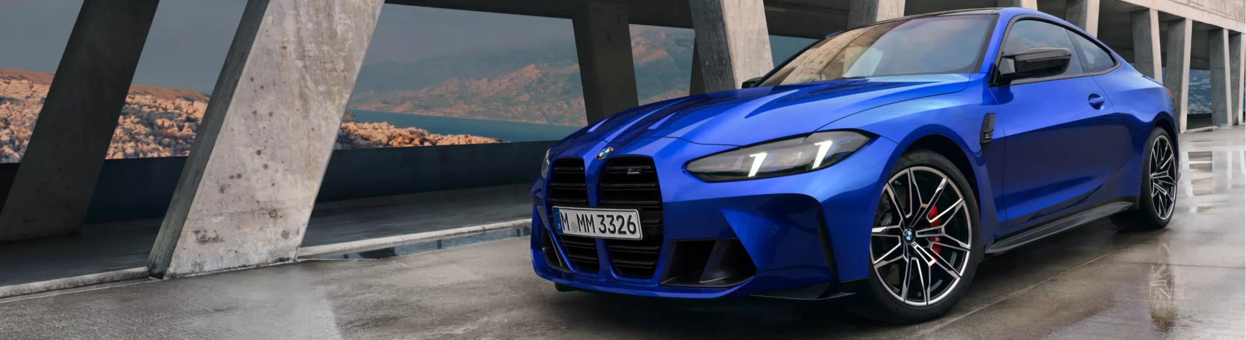 BMW M4 Competition Coupé Exterior View on a wet concrete bridge across a waterway