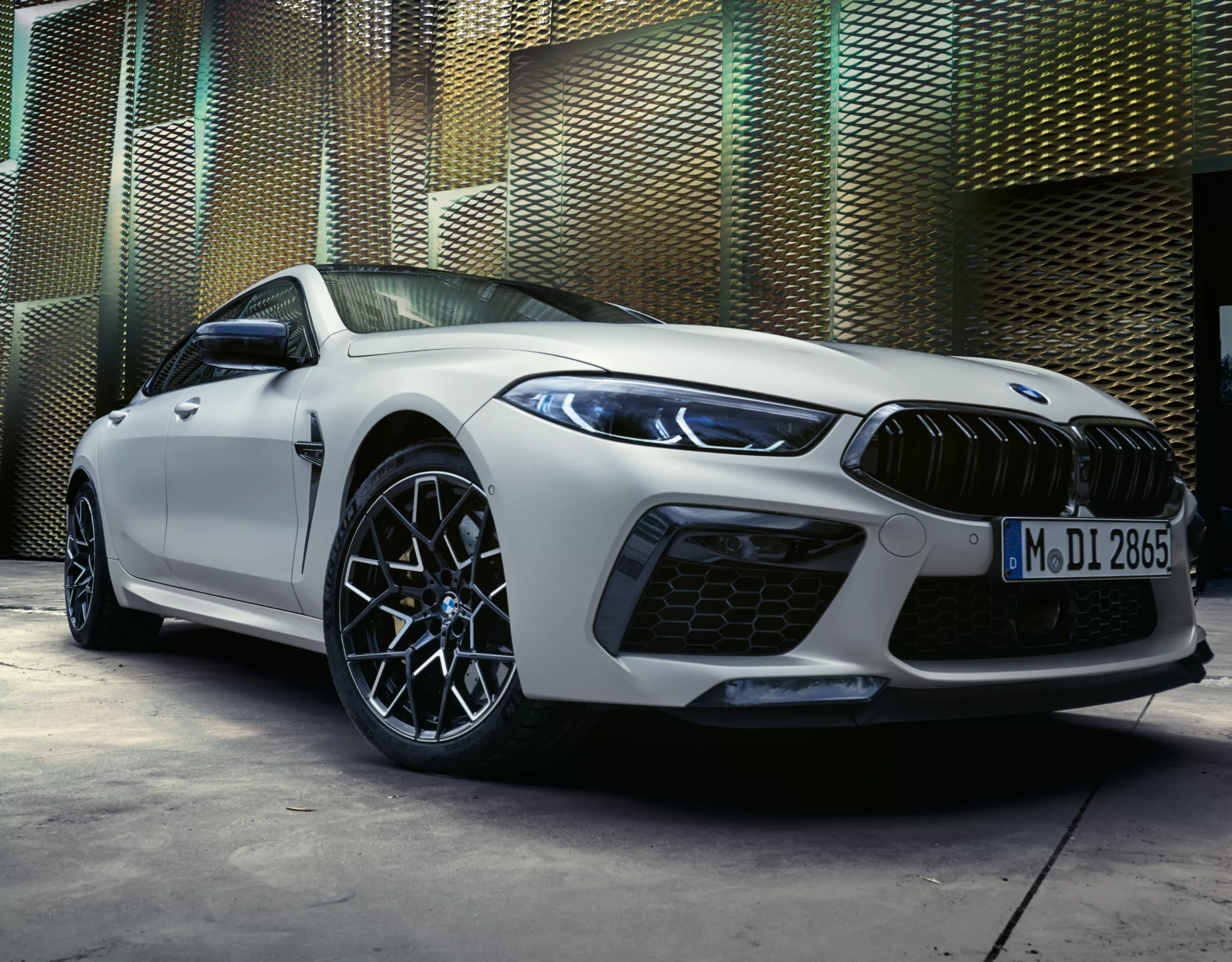 BMW M8 Competition Gran Coupé with golden architecture in the background