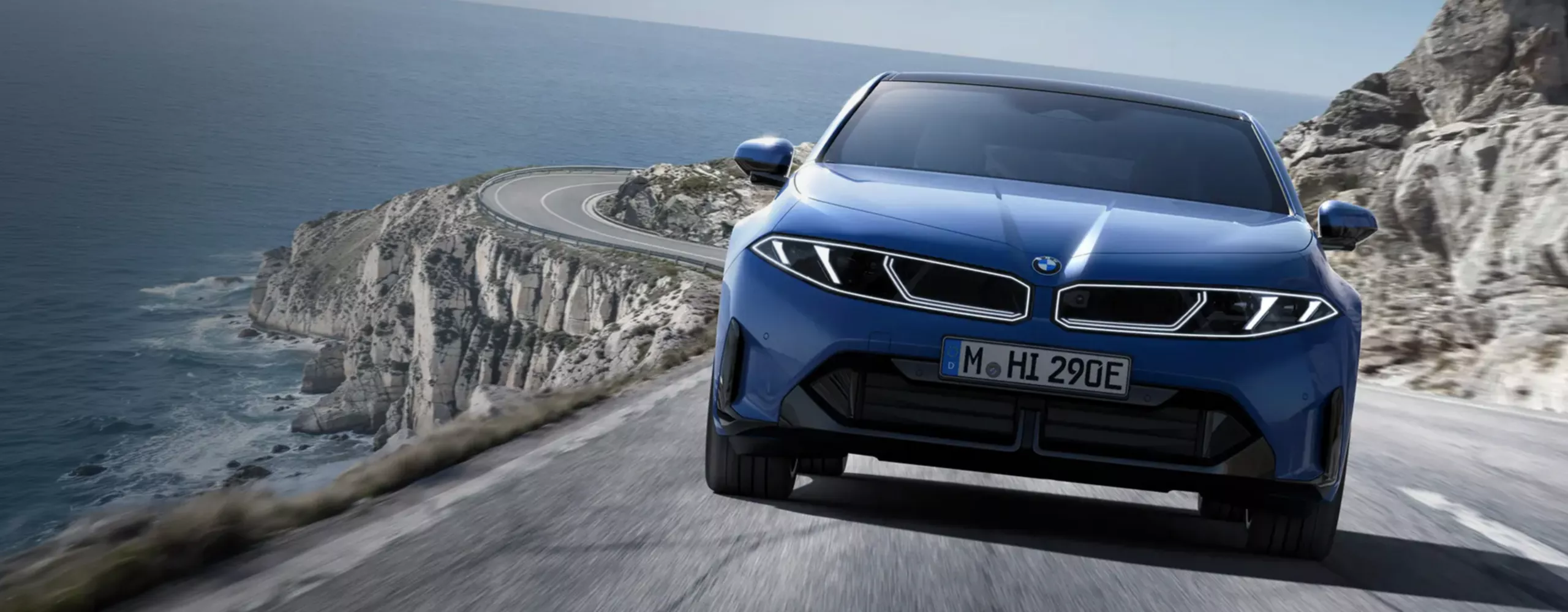 A dynamic driving video showcases the vehicle from all angles as it navigates winding roads through a scenic landscape, driven by a male model.