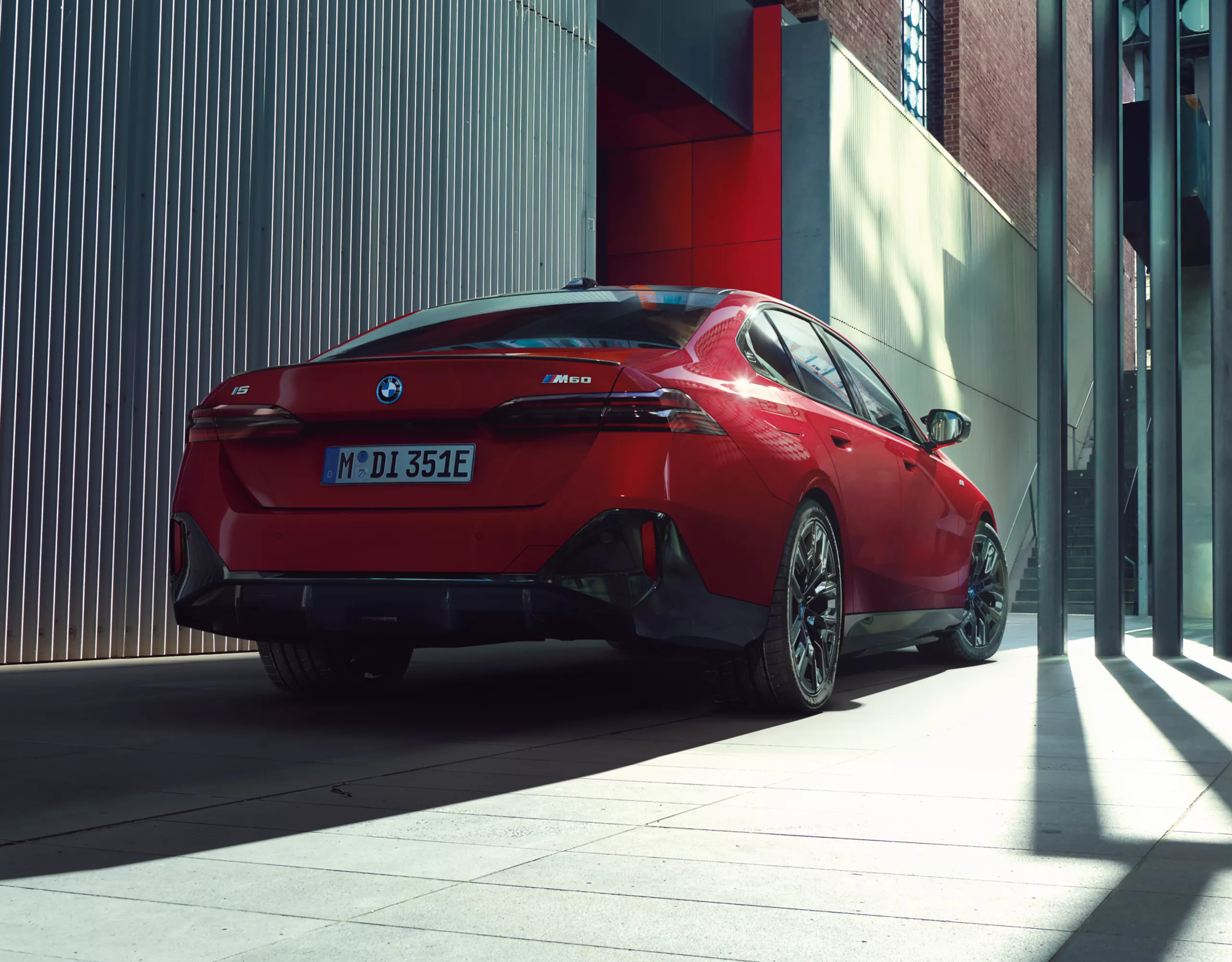 BMW i5 M60 xDrive red rear view 