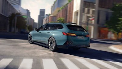 BMW i5 Touring green rear view