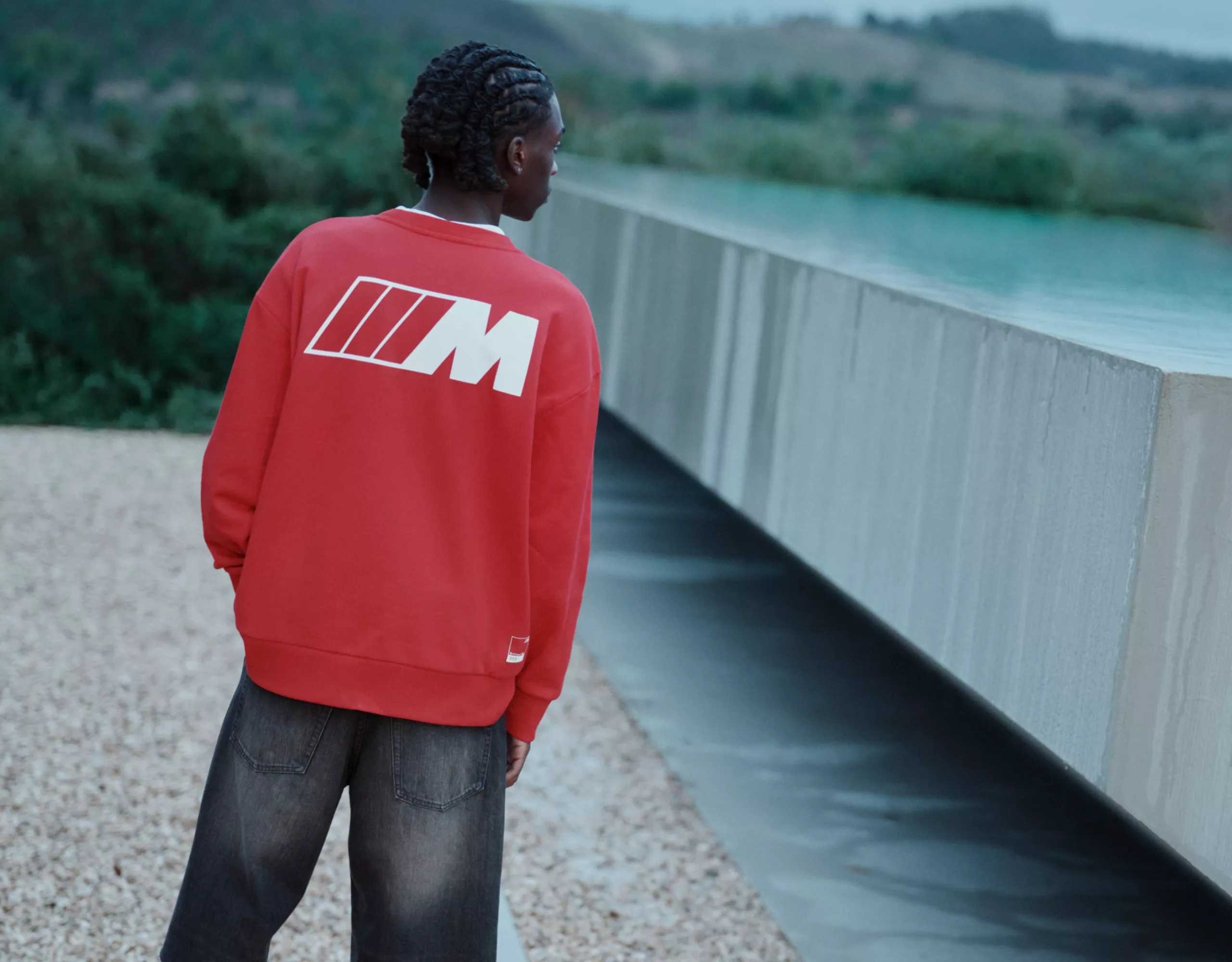 BMW Lifestyle Shirt with long sleeves in red with white M logo contours on the back, worn by a young man