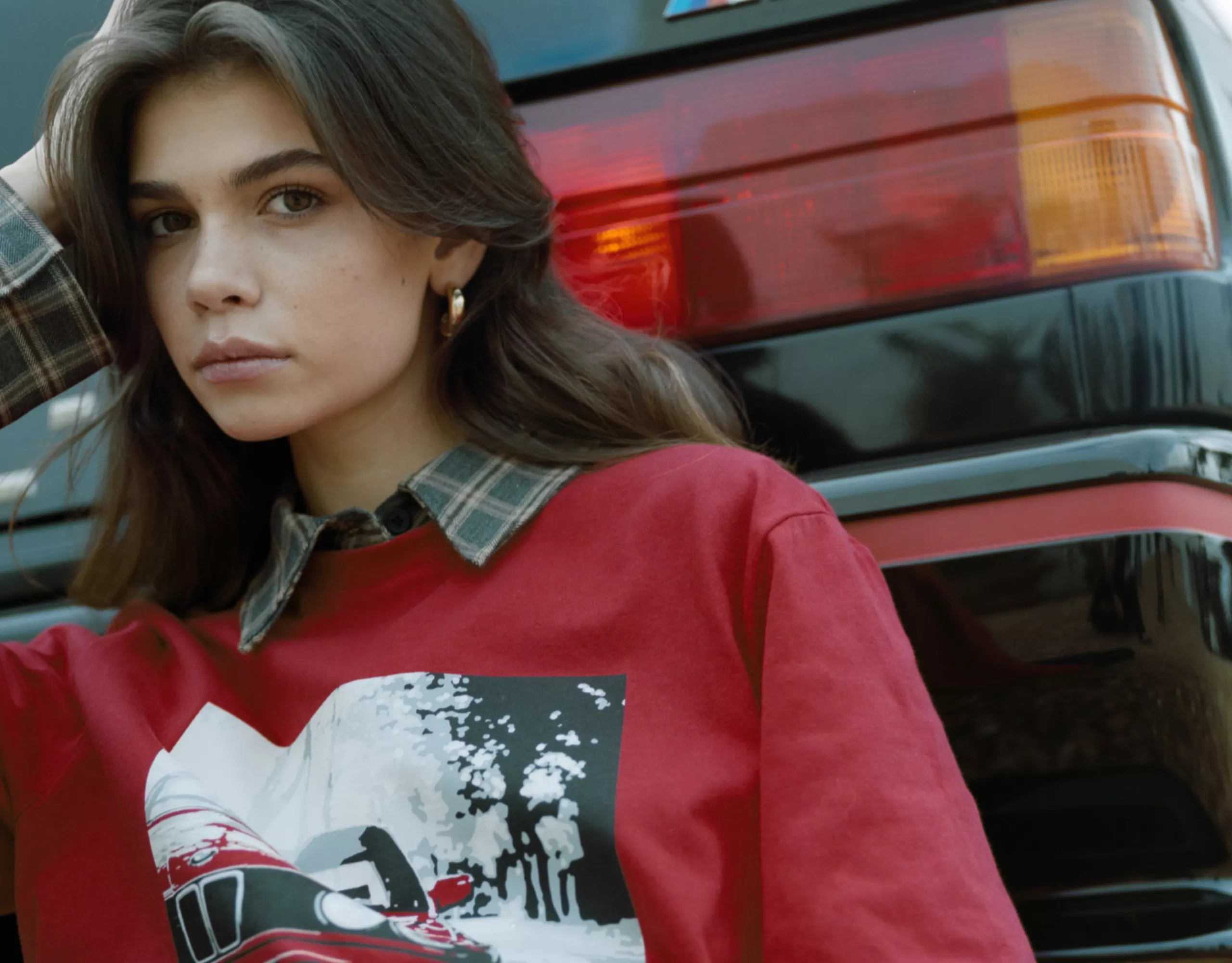 BMW Lifestyle Shirt red BMW shirt with a large print on the chest, worn by a young woman
