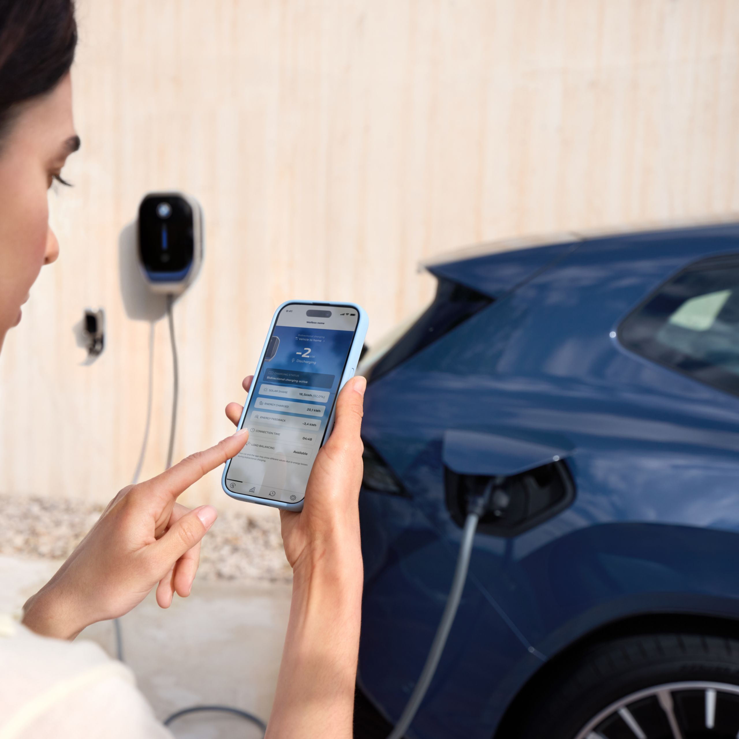 Smartphone with My BMW App lying on marble surface