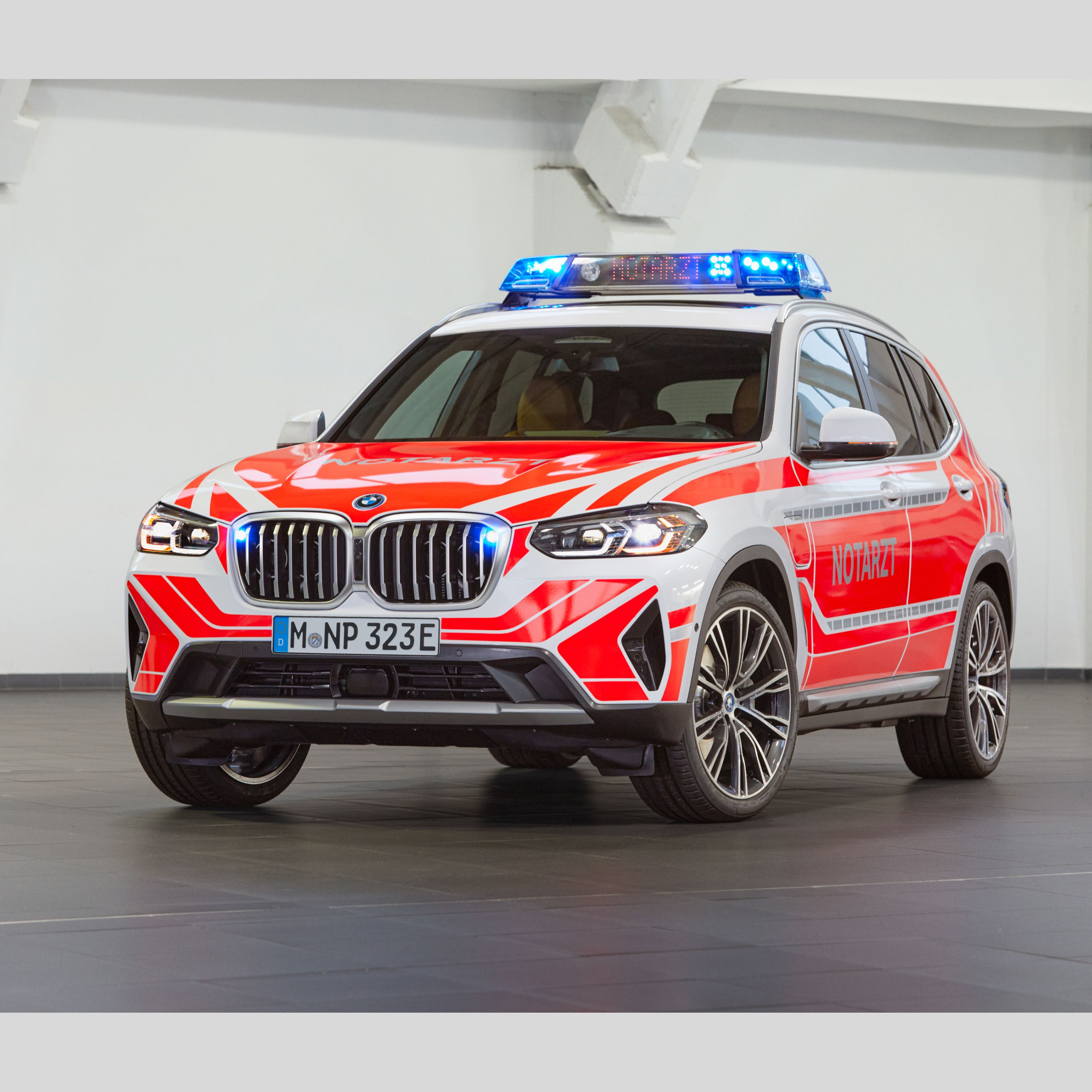 A BMW emergency medical vehicle in front of a white wall