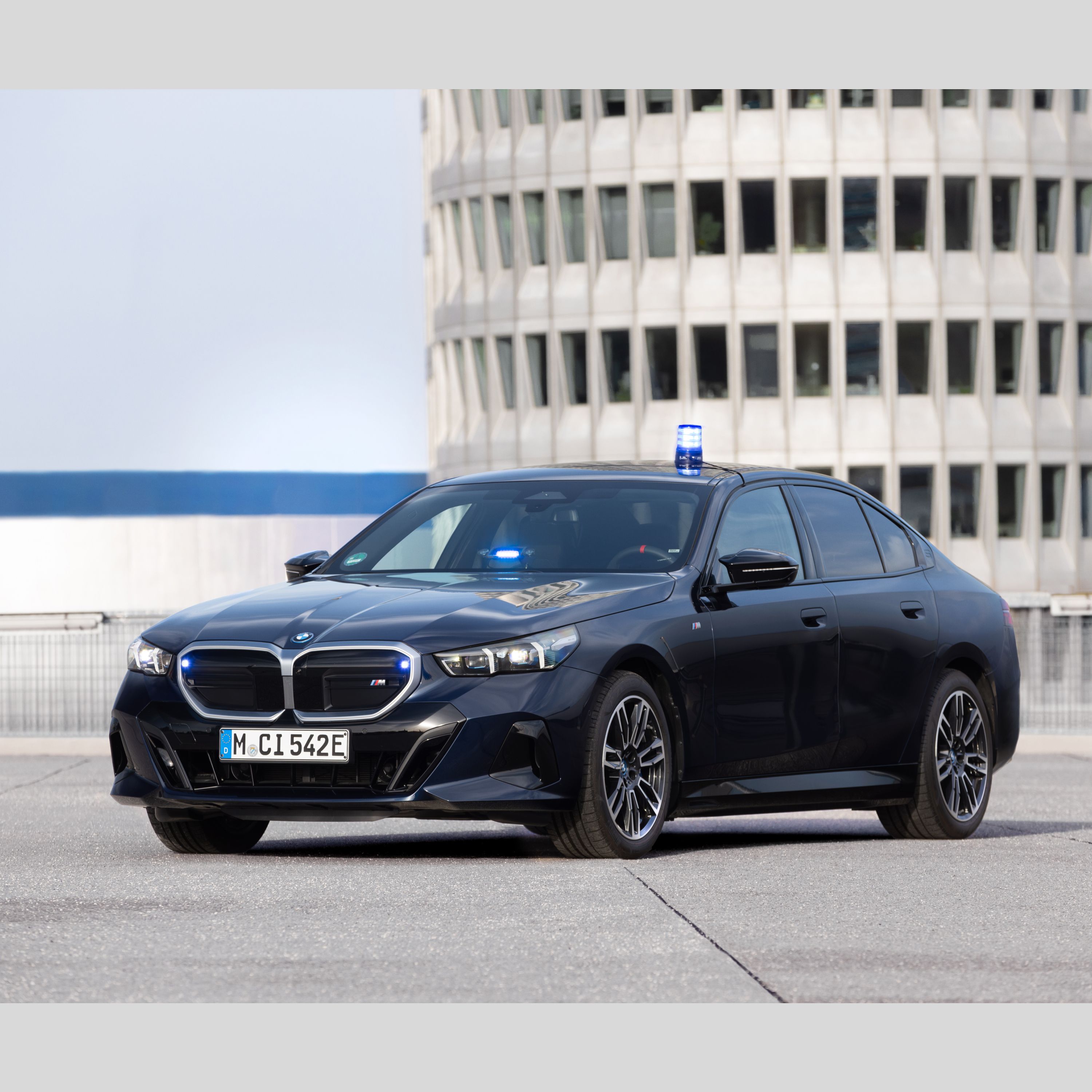 A BMW Authority Vehicle in a parking space in front of an office building
