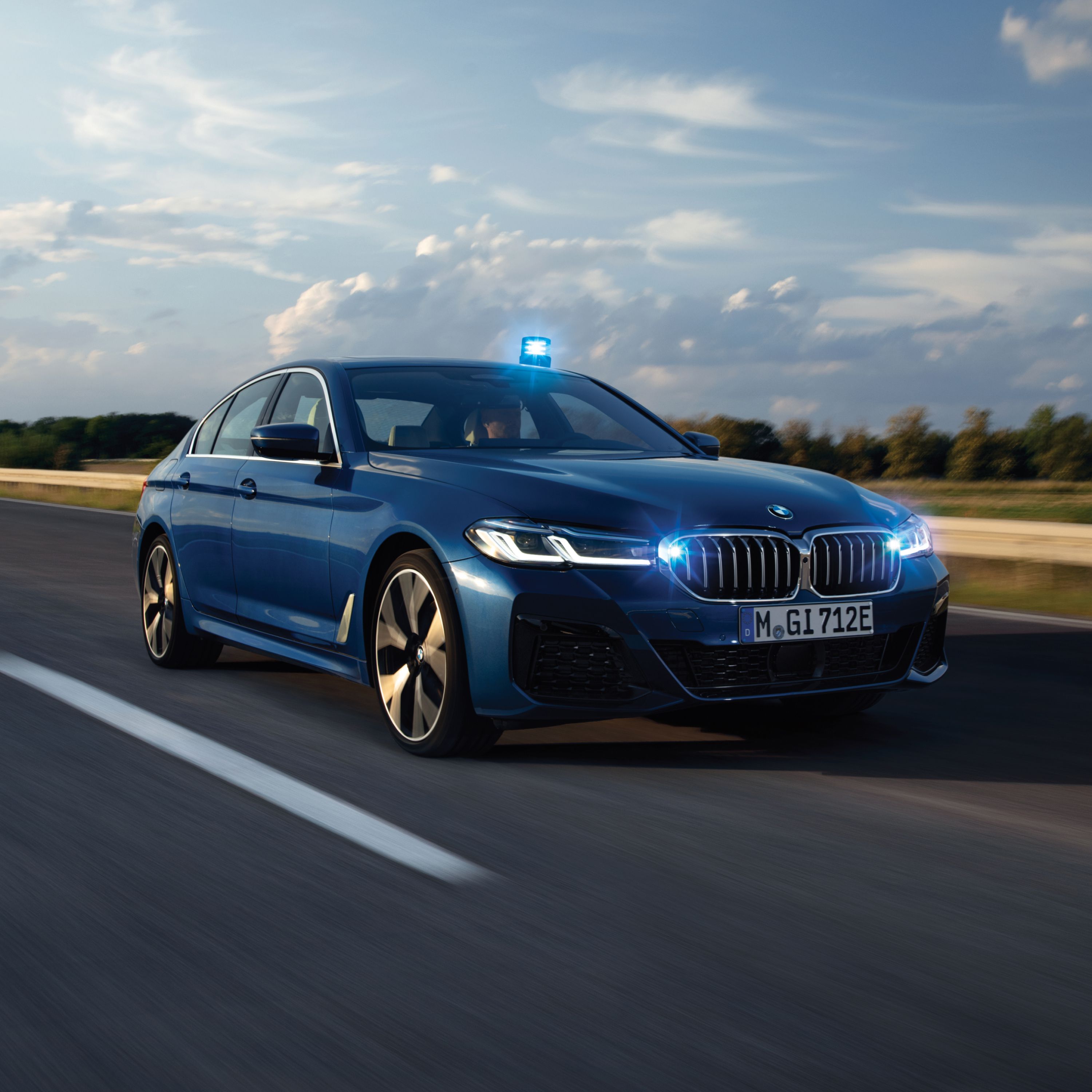 A BMW Authority Vehicle drives along a road