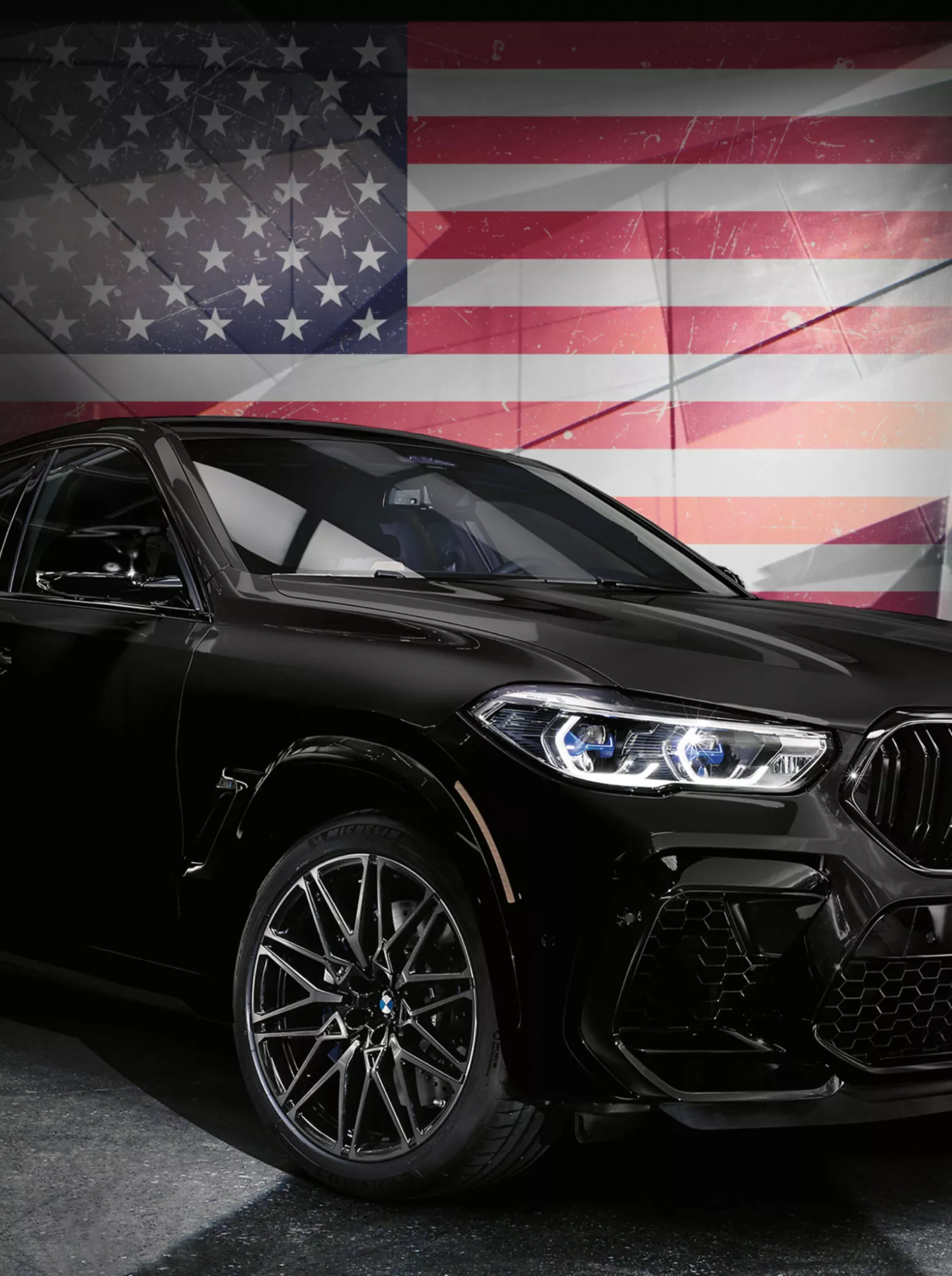 A BMW in front of an American flag