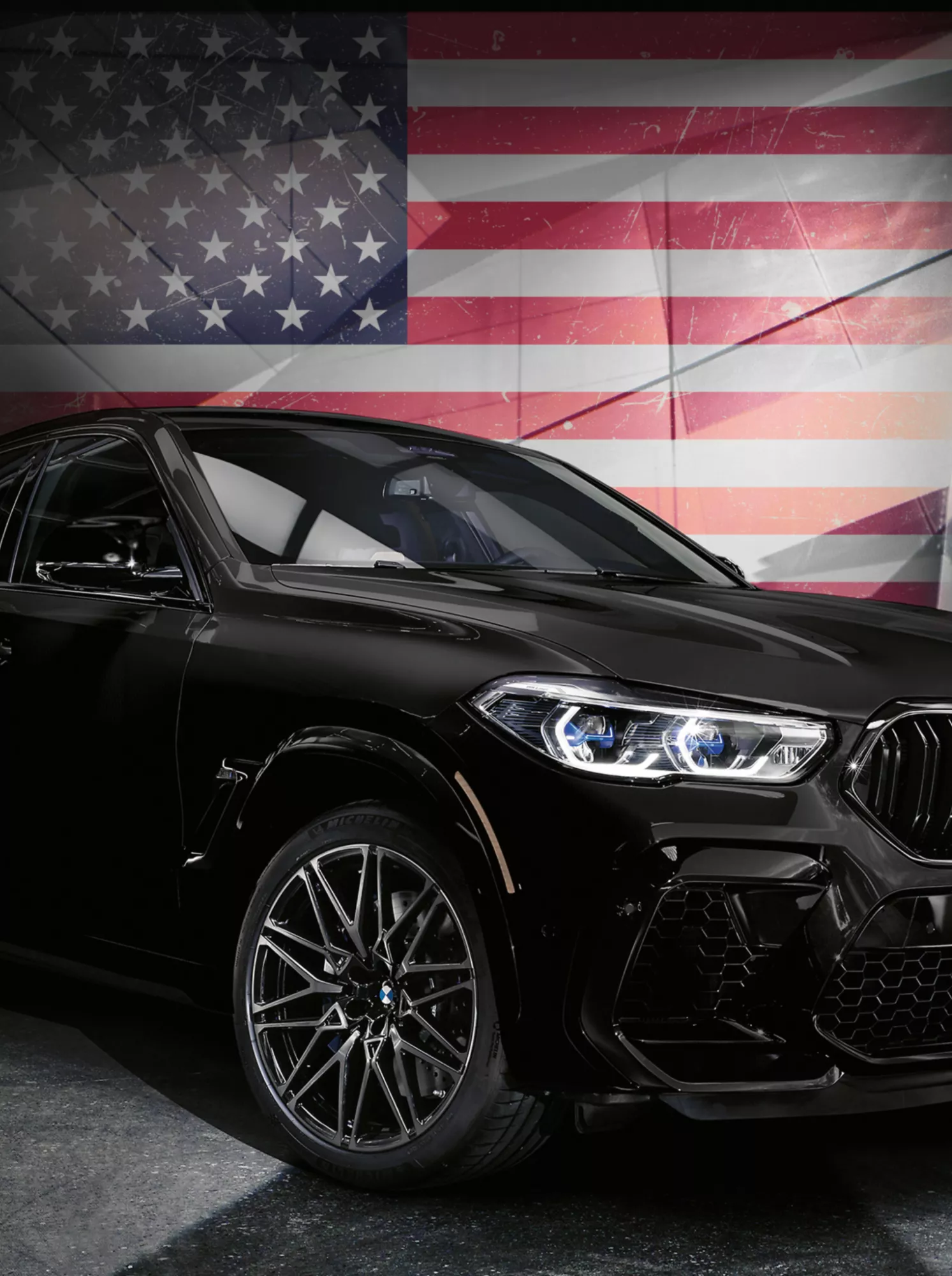 A BMW in front of an American flag