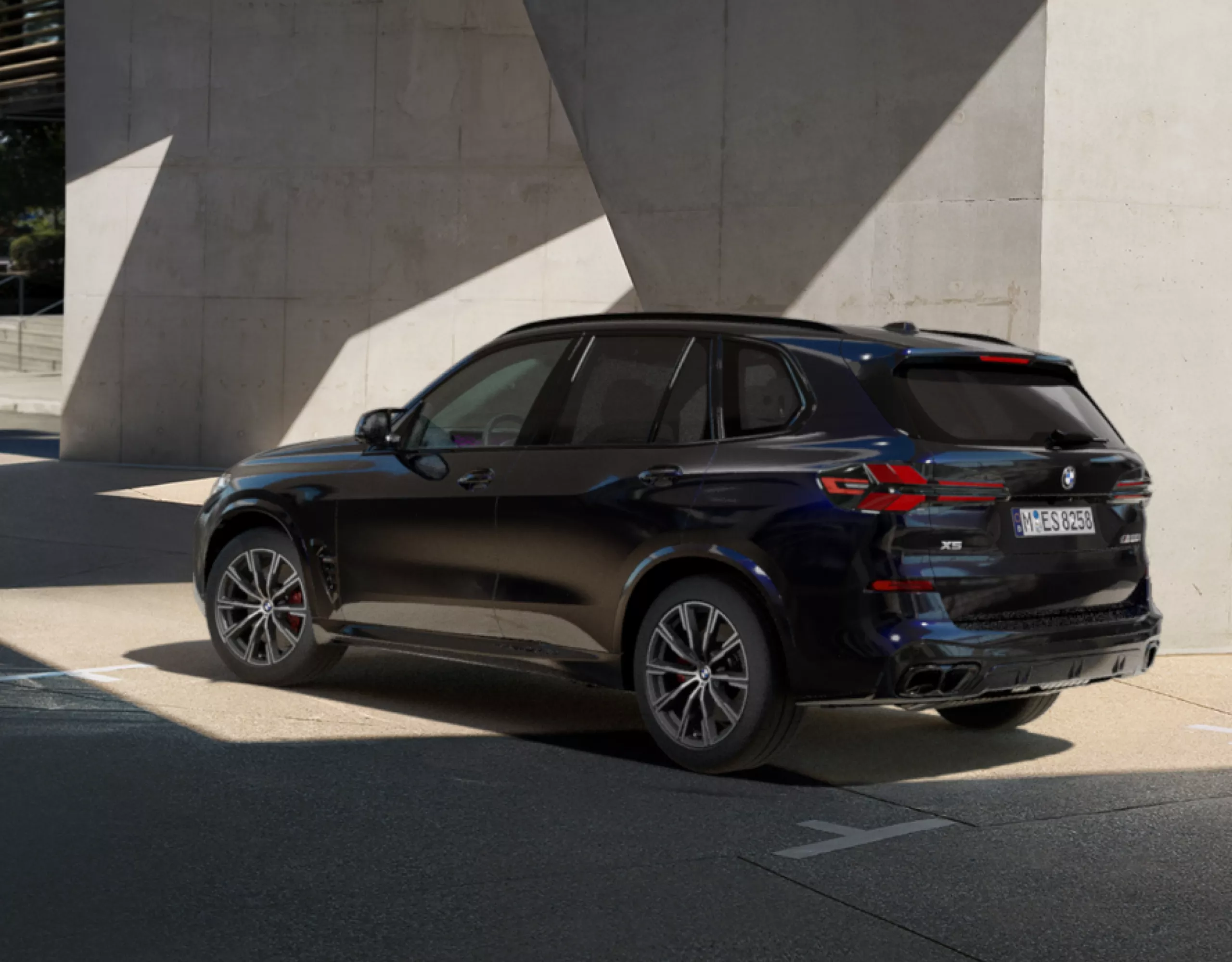 A BMW Protection Vehicle parked next to a concrete wall
